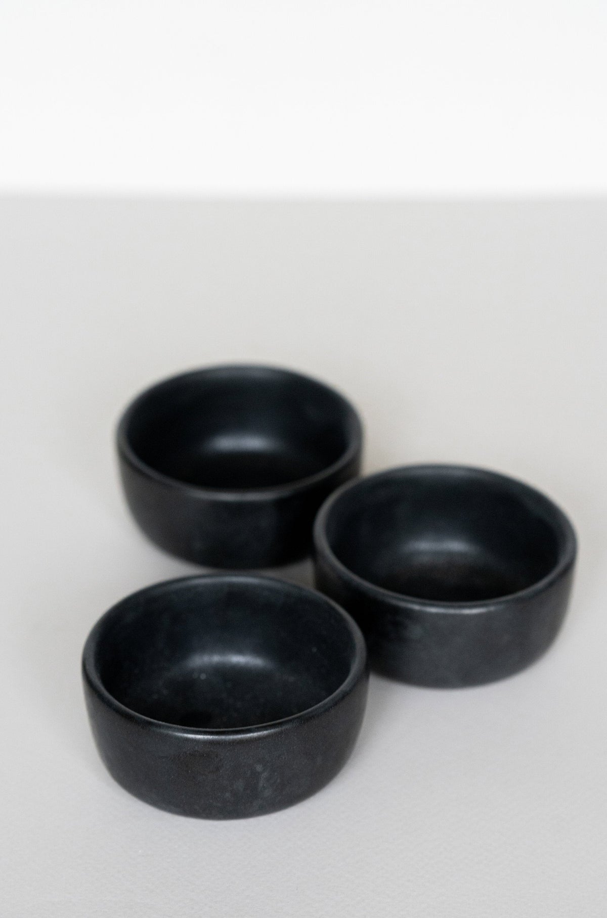 Black matte stoneware pinch bowl handcrafted in Ukraine, dishwasher and microwave safe, small condiment dish with food-safe glaze