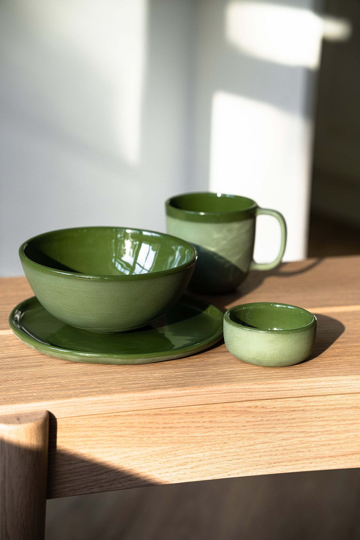 Set of green handmade porcelain dinner plates with shiny glaze, made in Ukraine