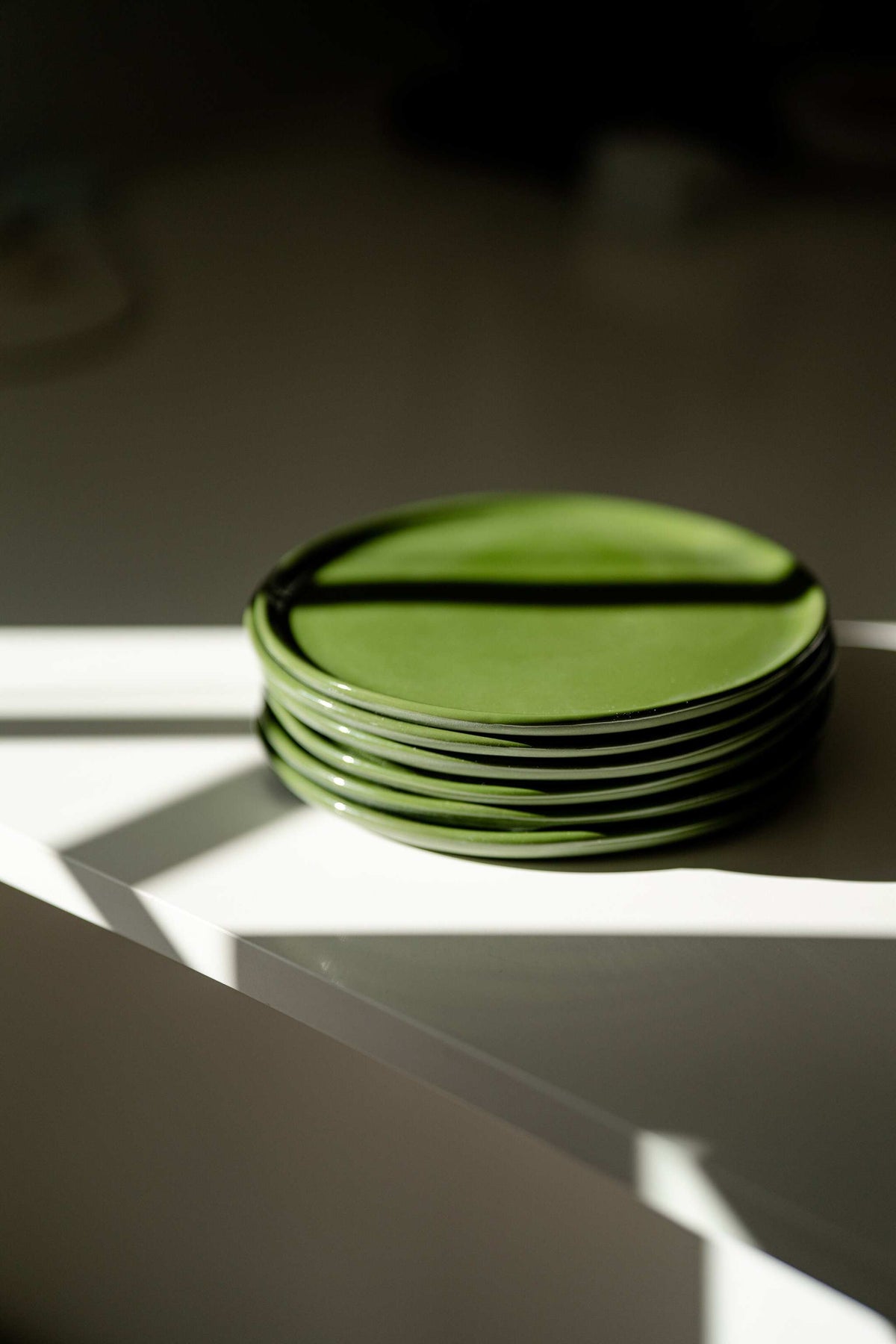 Handmade green porcelain dinner and salad plates with glossy glaze and smooth finish