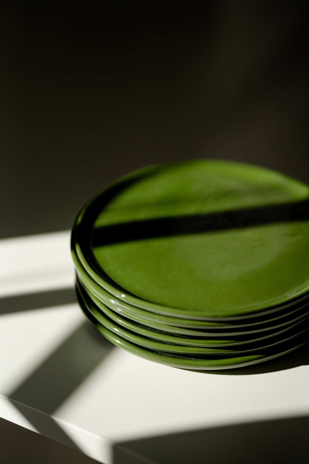 Handmade green porcelain dinner and salad plates with shiny glaze and polished finish