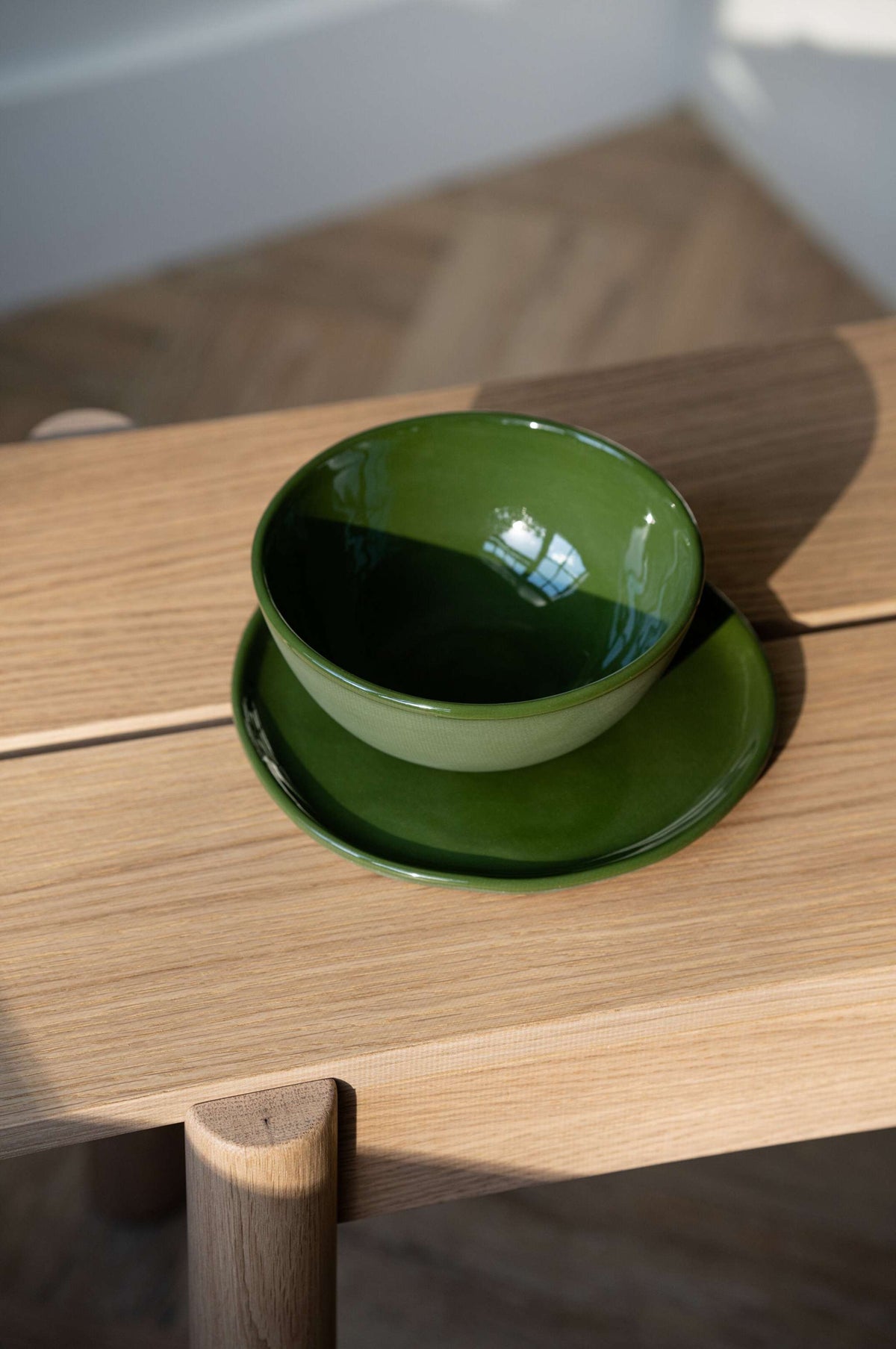 Handmade green porcelain dinner and salad plates with shiny glaze and polished finish