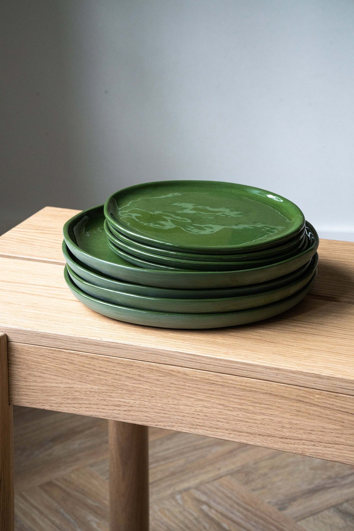 Handmade green porcelain dinner plates set with shiny glaze and smooth finish