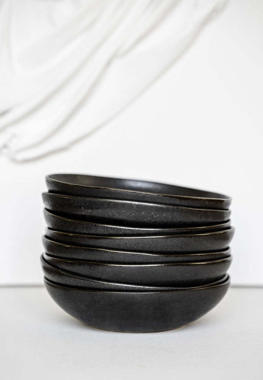 Black matte stoneware pasta bowl with high sides and glossy speckled reactive glaze, dishwasher and microwave-safe.