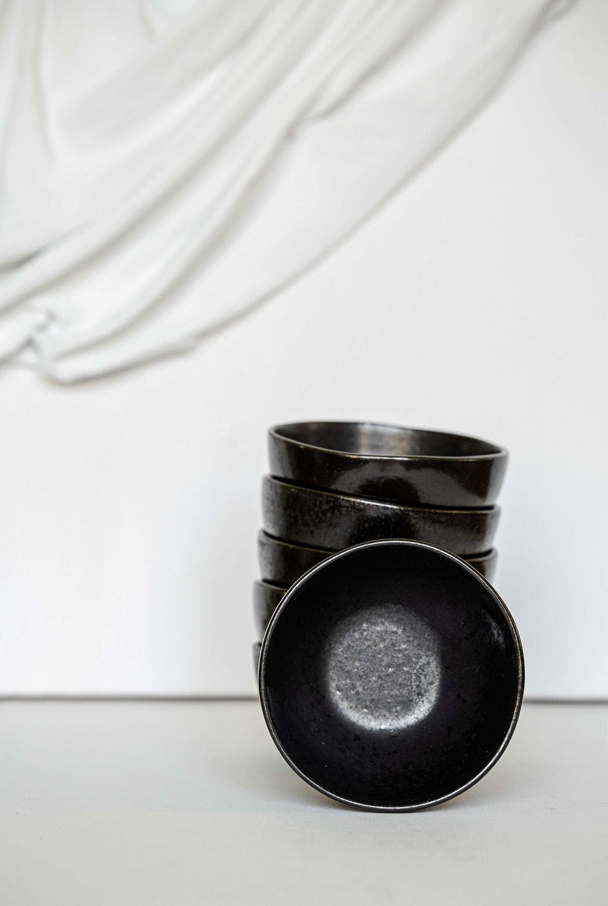 Black stoneware mini bowl with matte black glaze and glossy speckles, handmade in Portugal.