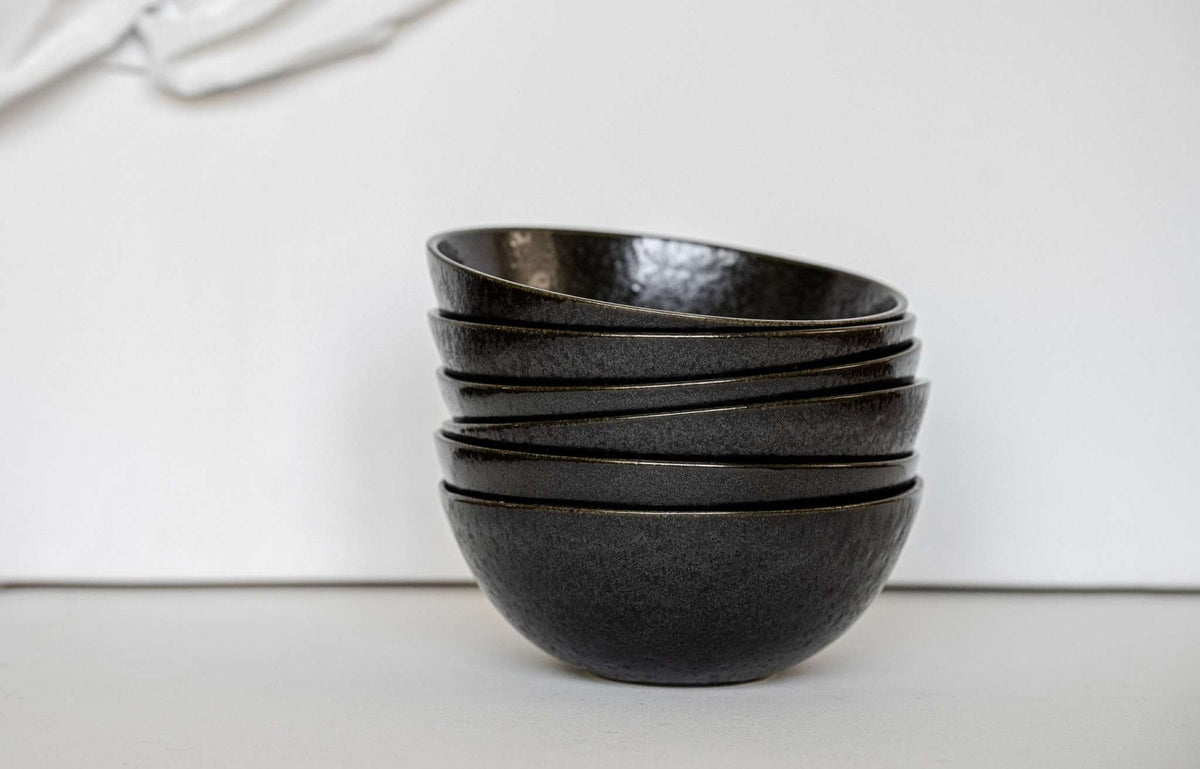Matte black stoneware everyday bowl with glossy speckles and organic curves, handmade in Portugal