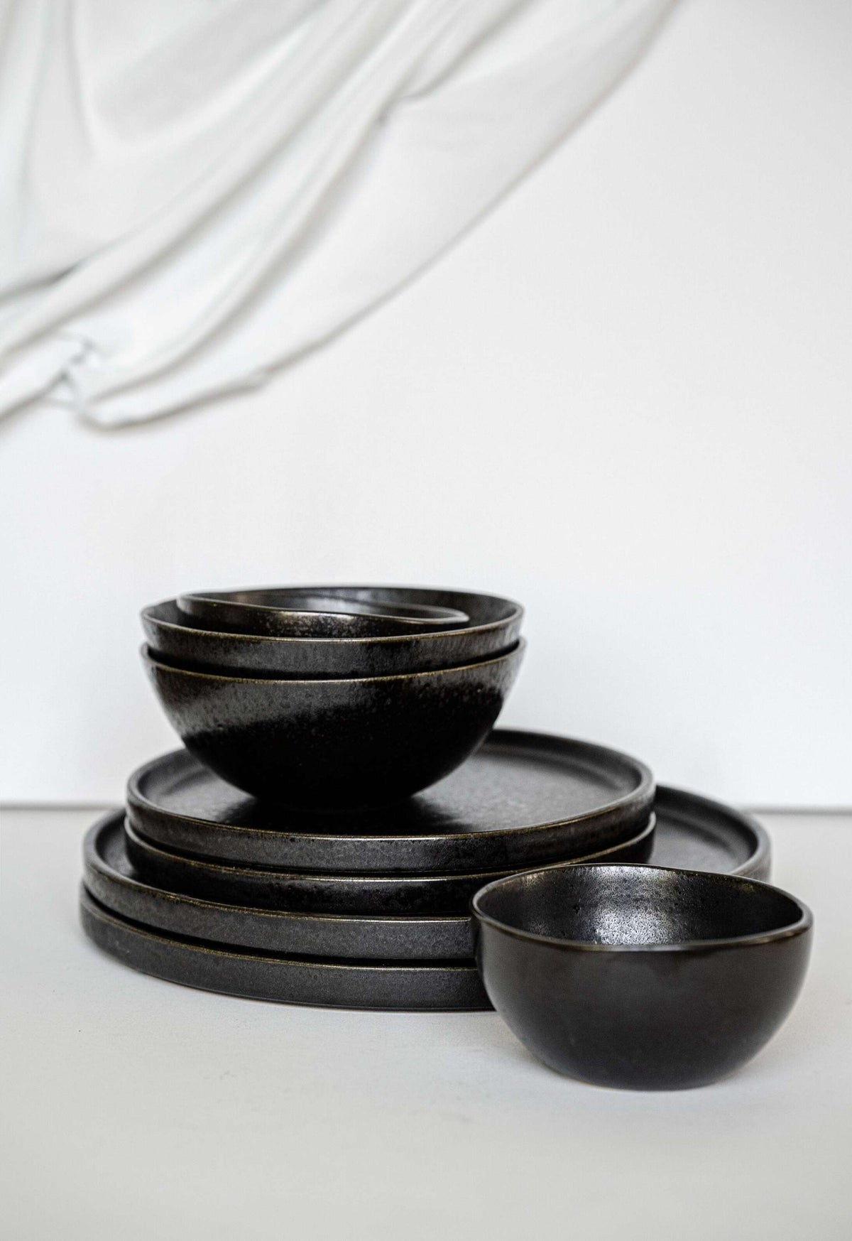 Handmade black stoneware everyday bowl with matte black glaze and glossy speckles, durable and food-safe.