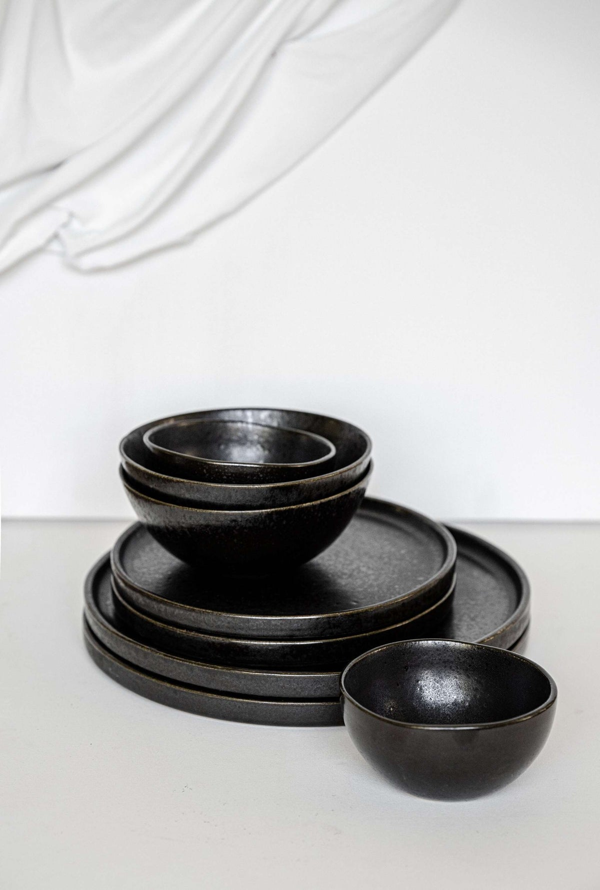 Handmade black stoneware mini bowl with matte glaze and glossy speckles, food-safe and durable