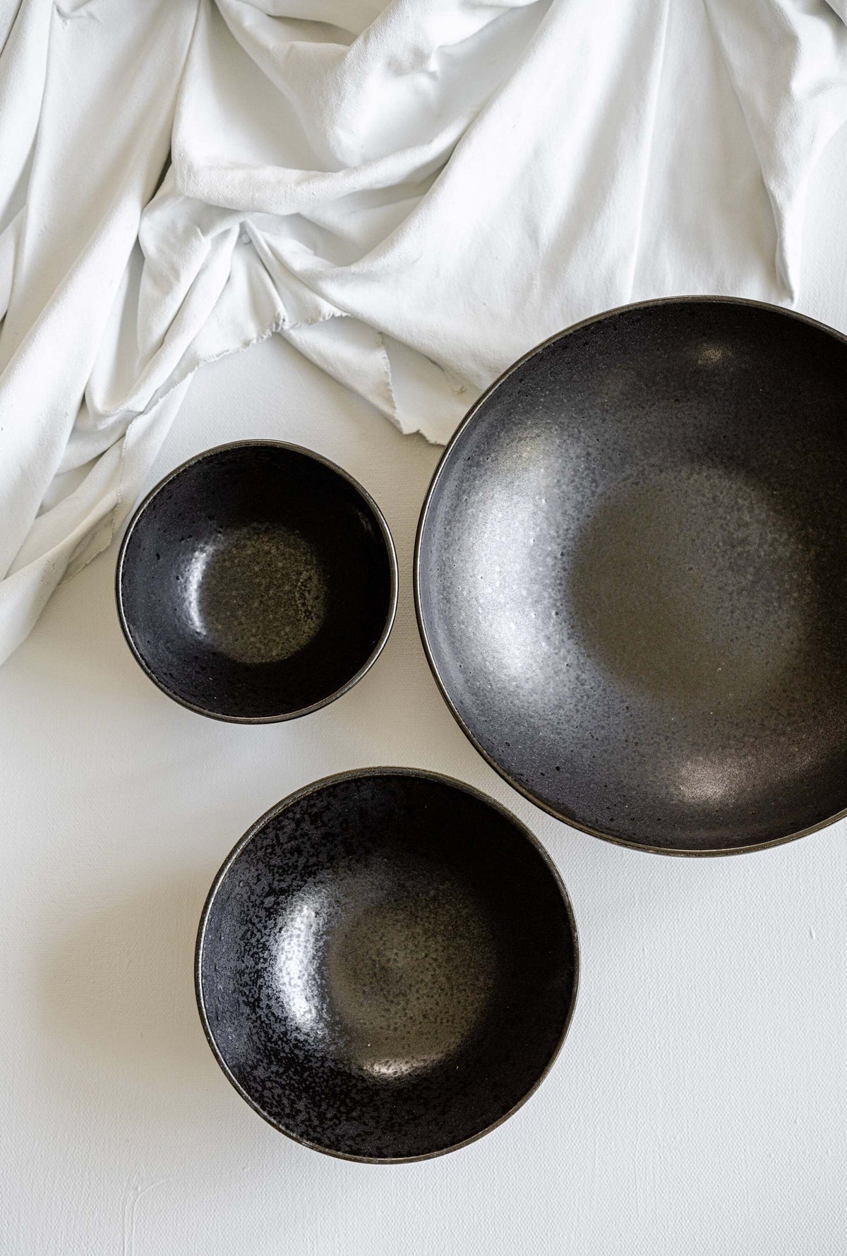 Black stoneware everyday bowl with matte black glaze and glossy speckles, handmade in Portugal