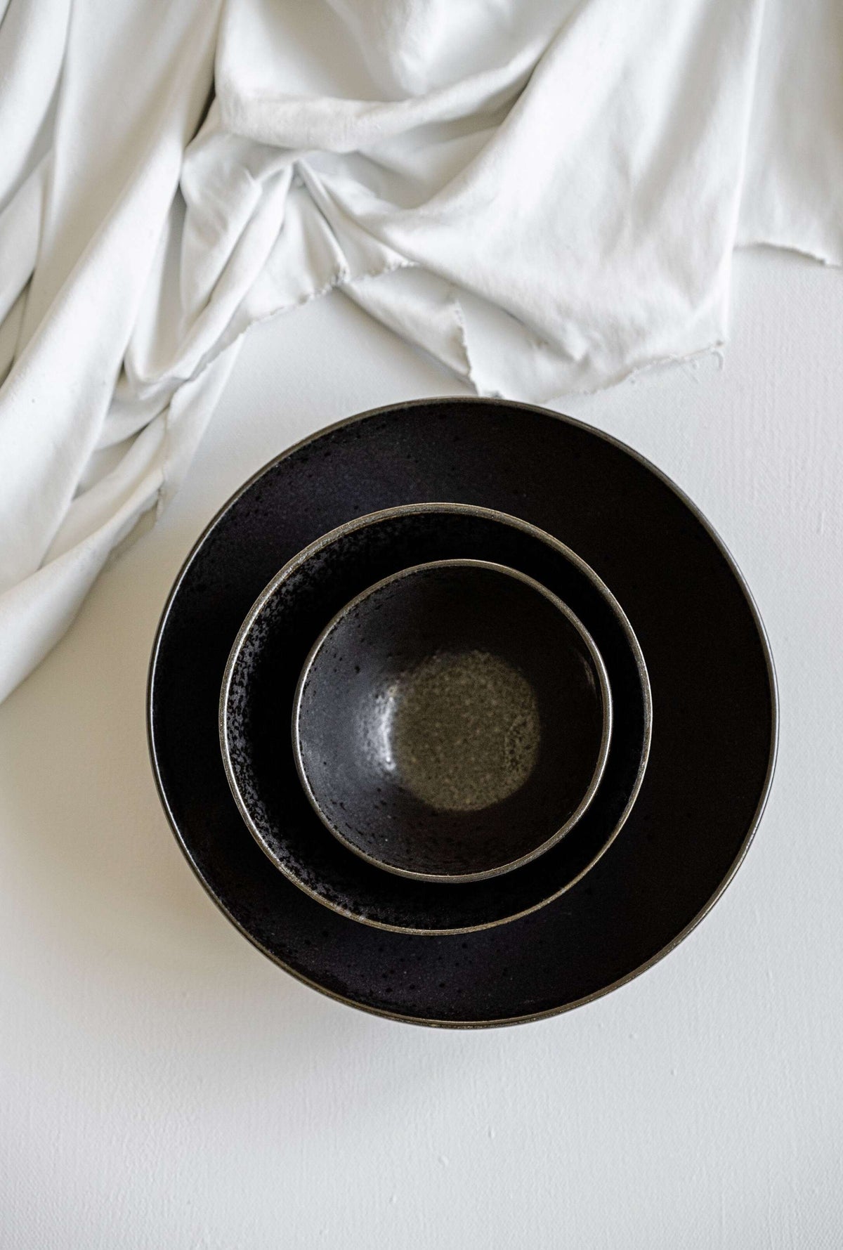 Black stoneware mini bowl with matte glaze and glossy speckles, handmade in Portugal