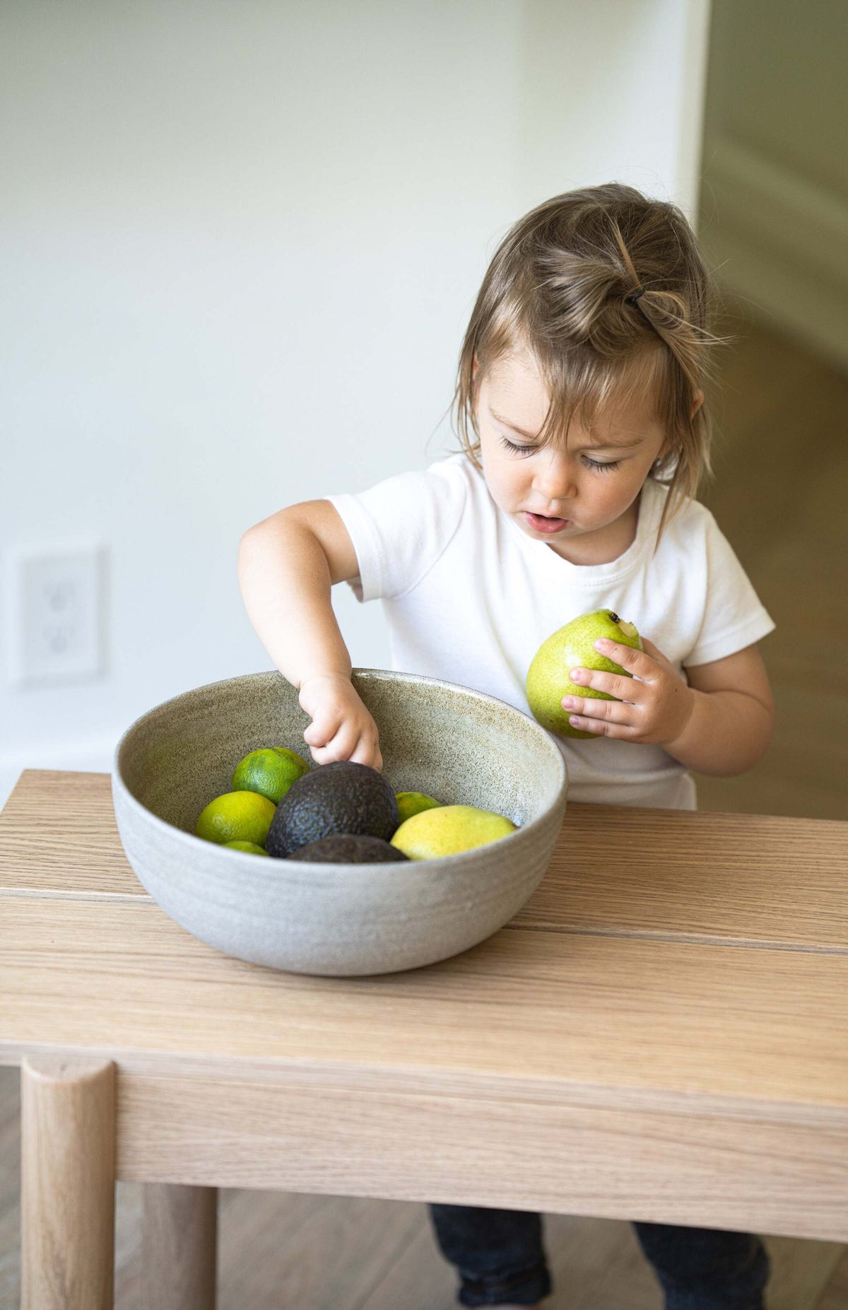 Stoneware large fruit bowl Concrete with polished exterior and glossy interior filled with fresh fruits