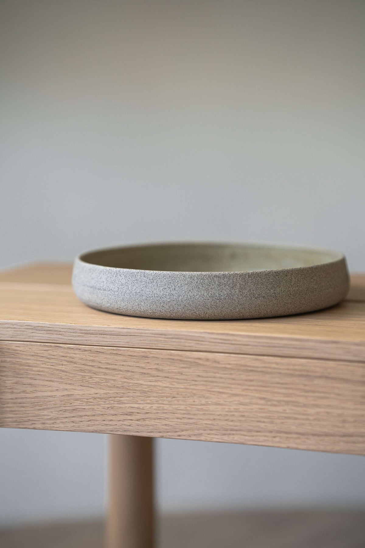 Handmade stoneware salad plate with high sides in concrete-inspired design, durable and dishwasher-safe