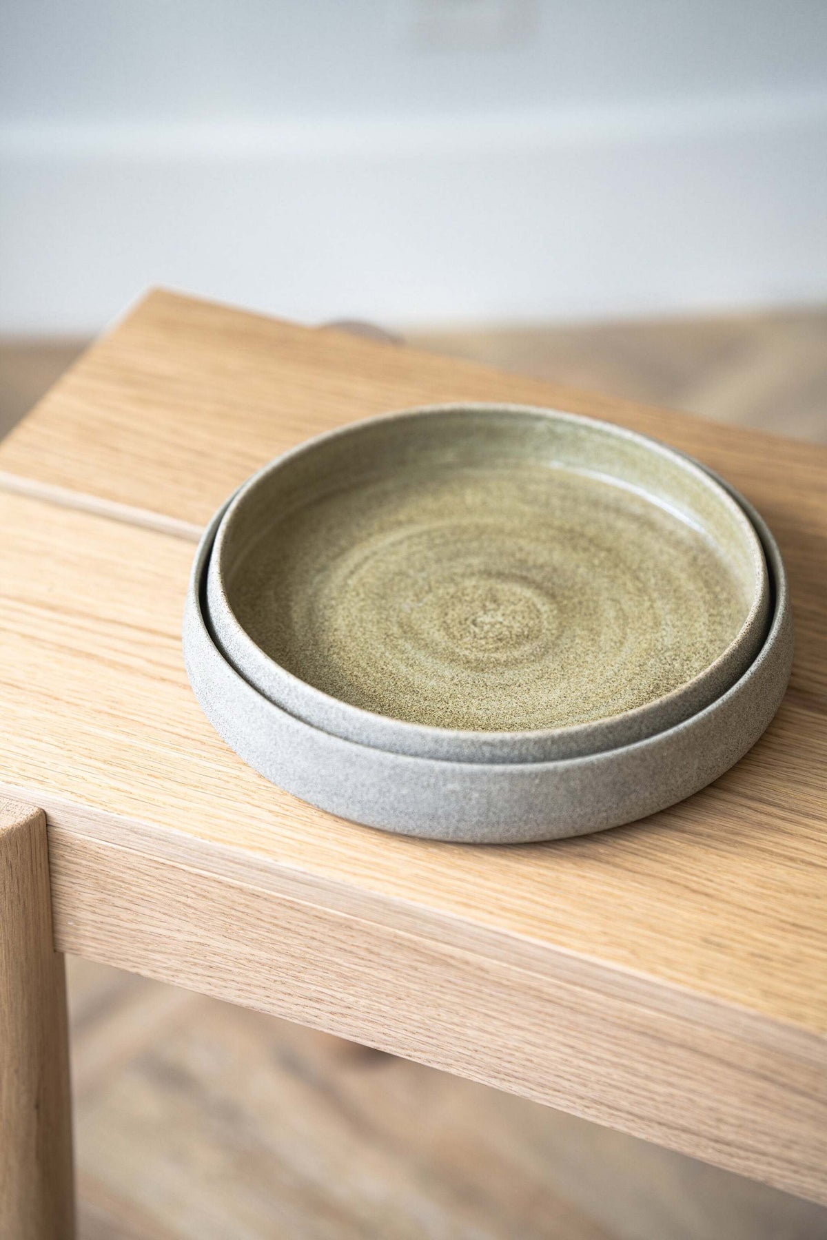 Handmade stoneware salad plate with concrete-inspired texture and high sides for salads