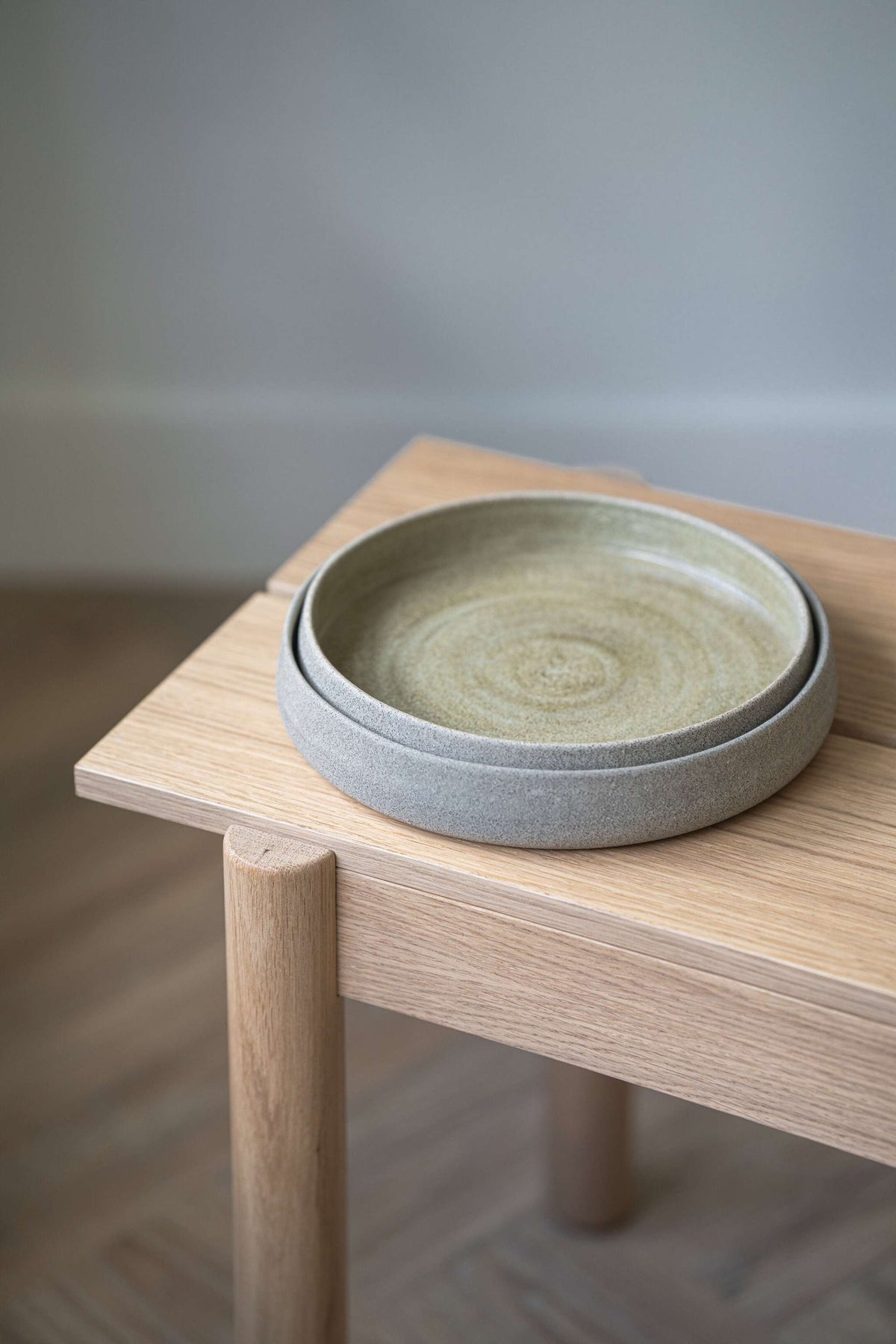 Handmade stoneware salad plate with high sides and concrete-inspired design