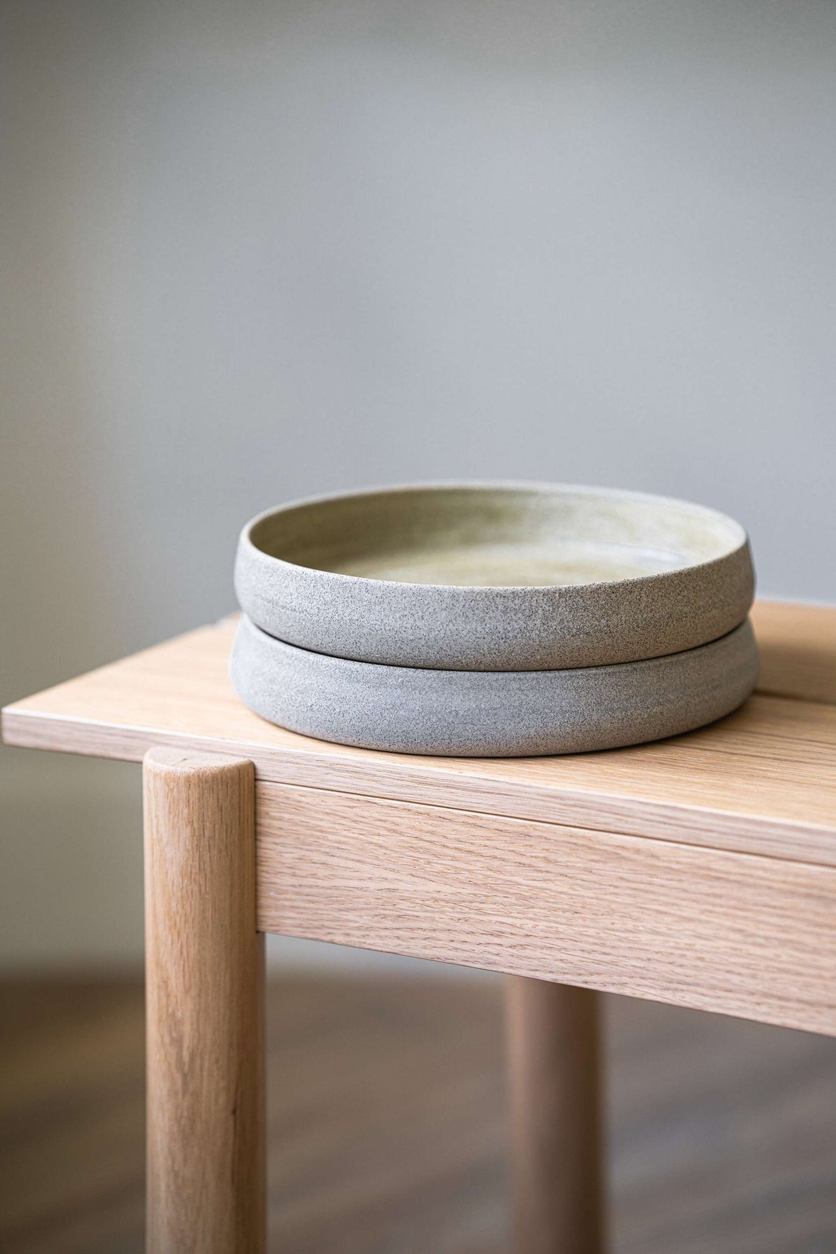 Handmade stoneware salad plate with high sides and concrete-inspired textured exterior