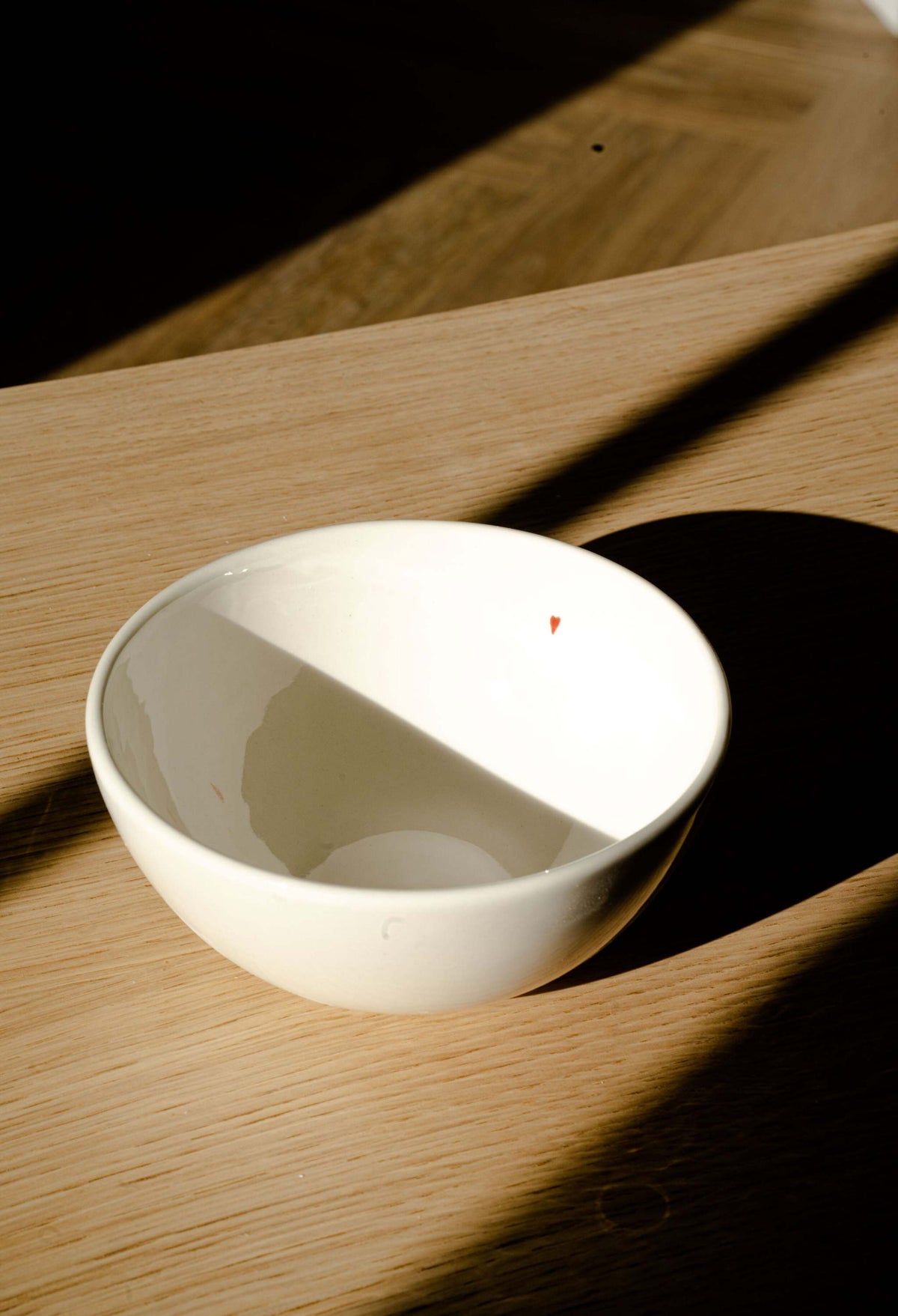 Off-white handmade porcelain bowl with shiny glaze, small red heart, and "Thanks Love Happiness" inscription, food-safe and dishwasher safe