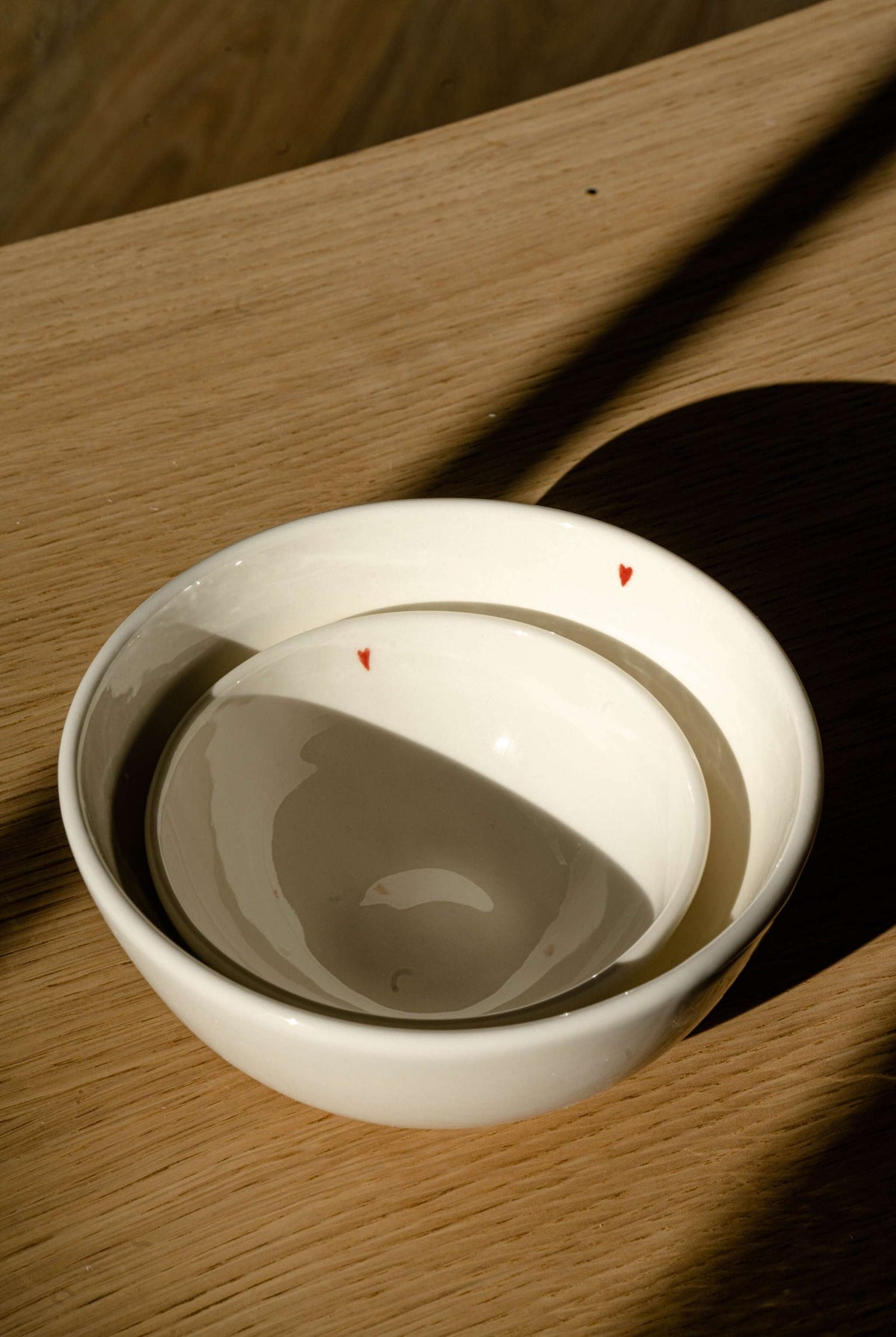 Handmade off-white porcelain bowl with red heart and gratitude message, food-safe and dishwasher-safe.