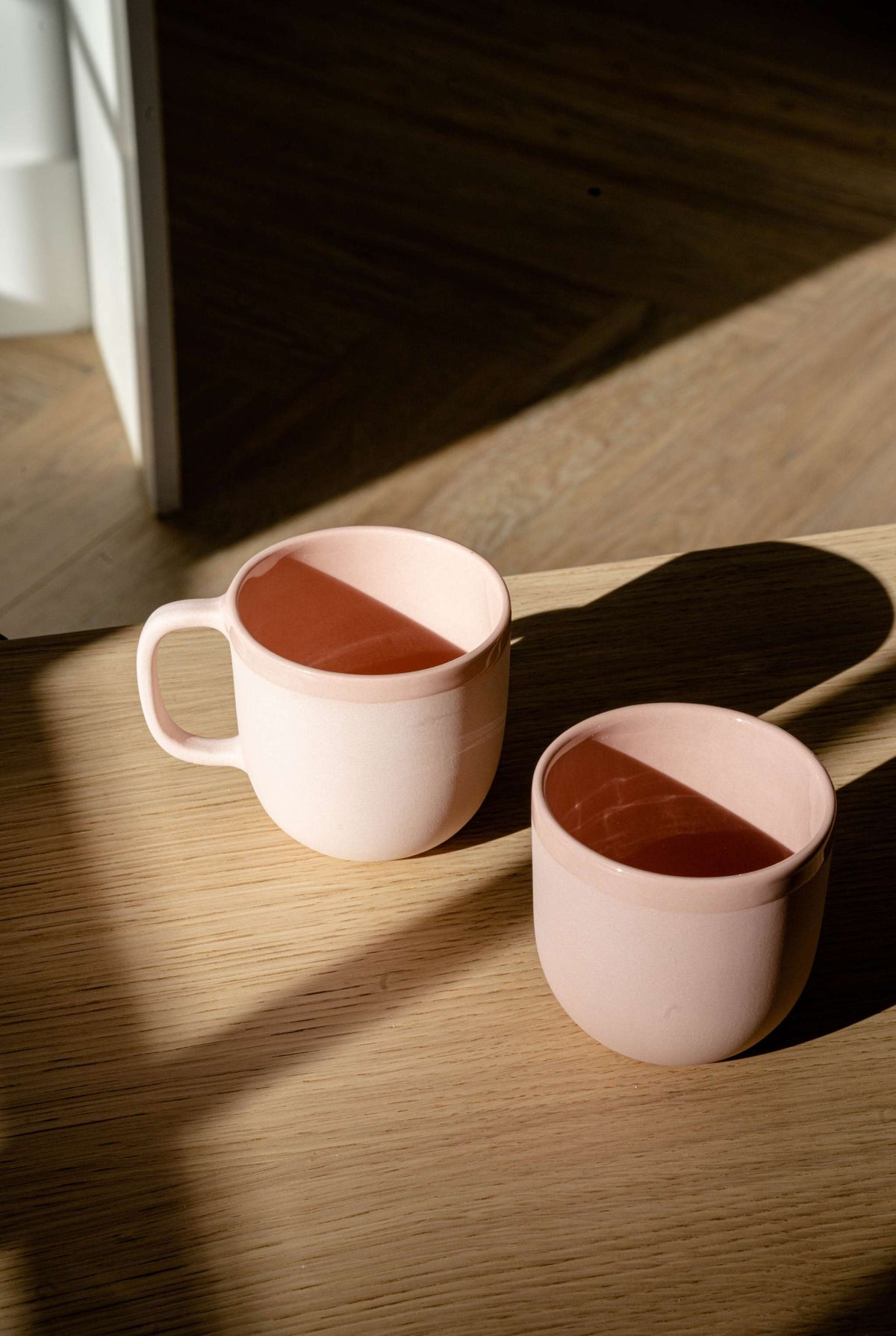 Handmade porcelain coffee cup in powder pink with shiny glaze and smooth finish