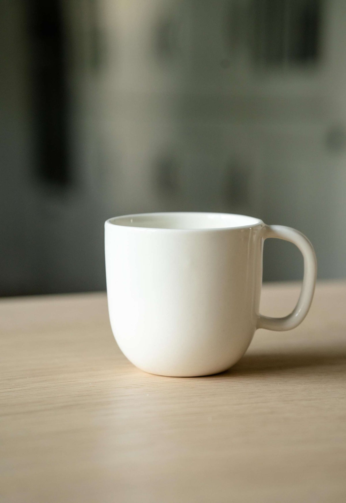 Handmade off-white porcelain coffee mug with shiny glaze, food-safe and lead-free, made in Ukraine