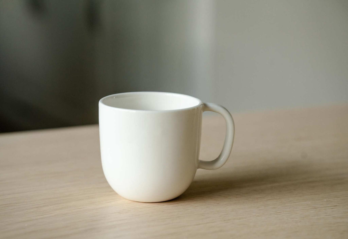 Handmade off-white porcelain coffee mug with shiny glaze, food-safe, dishwasher and microwave safe.