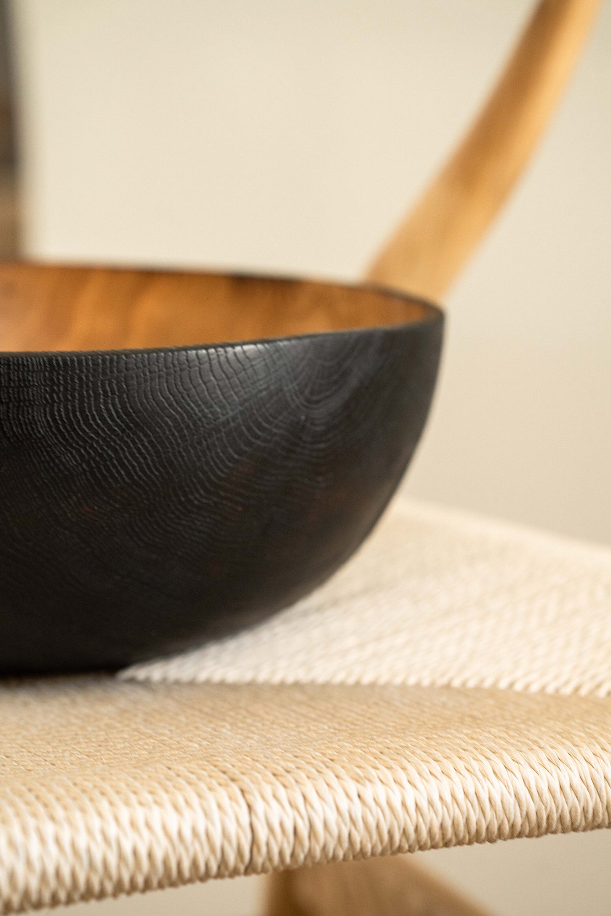 Hand carved large half charred wooden bowl with blackened exterior and natural wood texture
