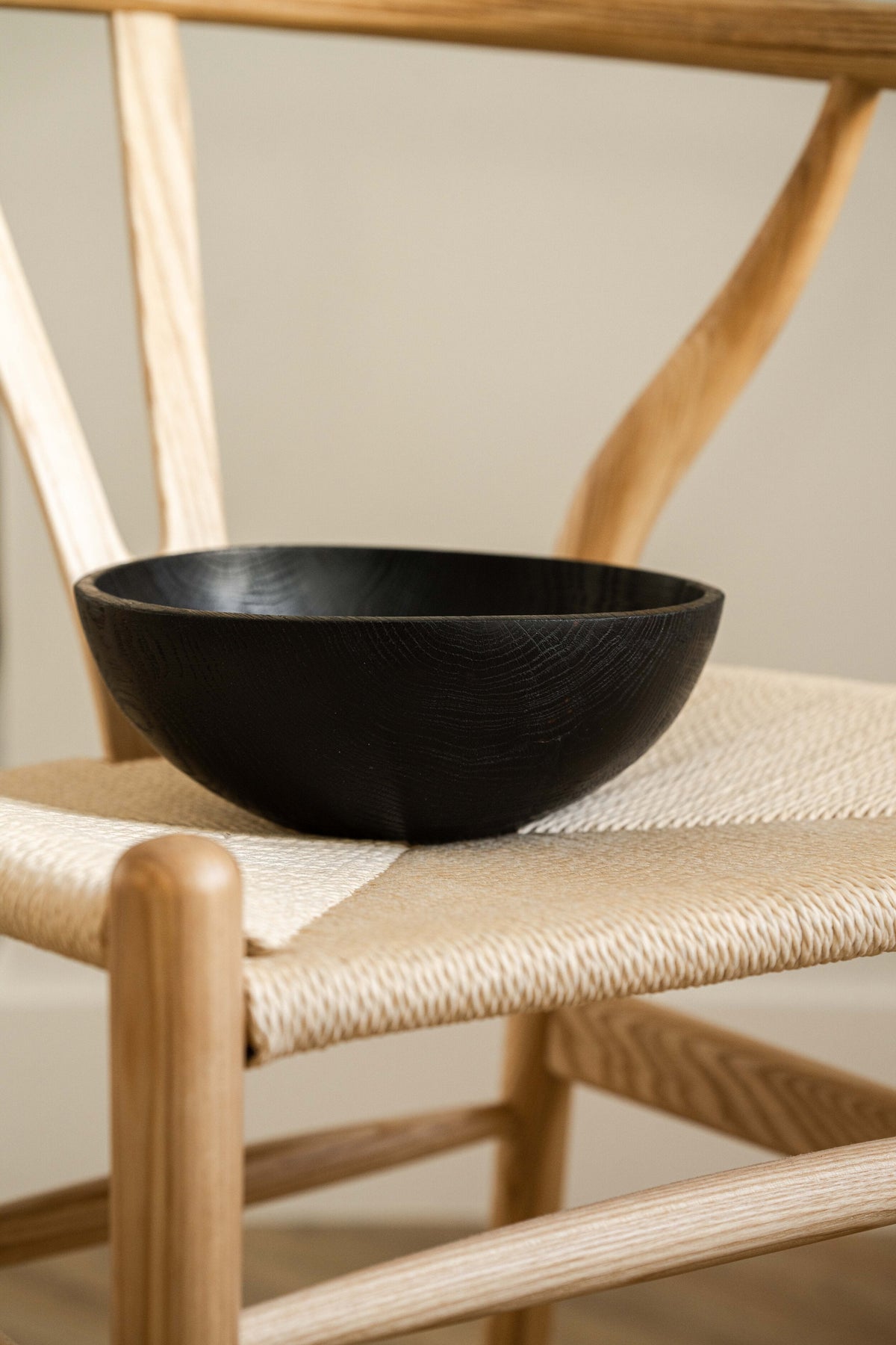 Hand-carved large charred ash wood bowl with food-safe finish, handmade in Ukraine, ideal for fruits and vegetables.