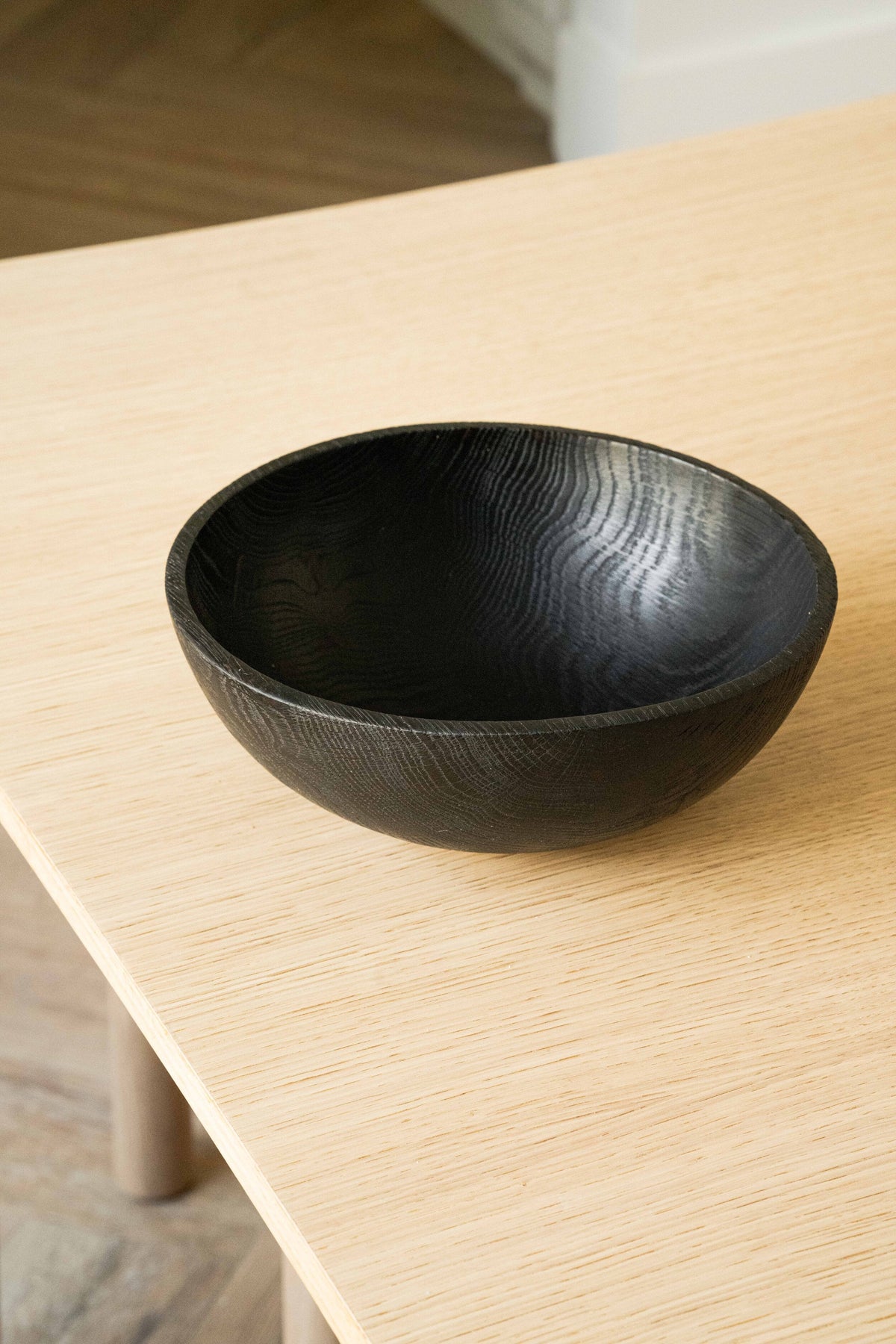 Hand-carved large charred wood bowl made from ash wood with black finish, perfect for fruit display.