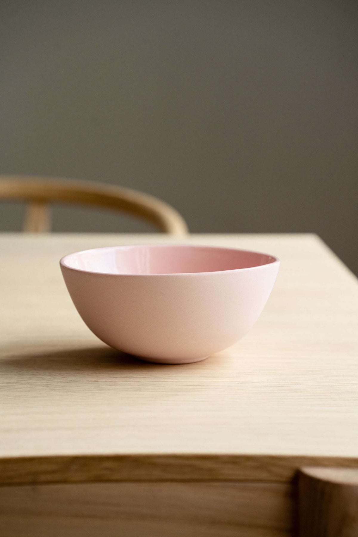 Handmade porcelain bowl in powder pink with shiny glaze and smooth polished exterior