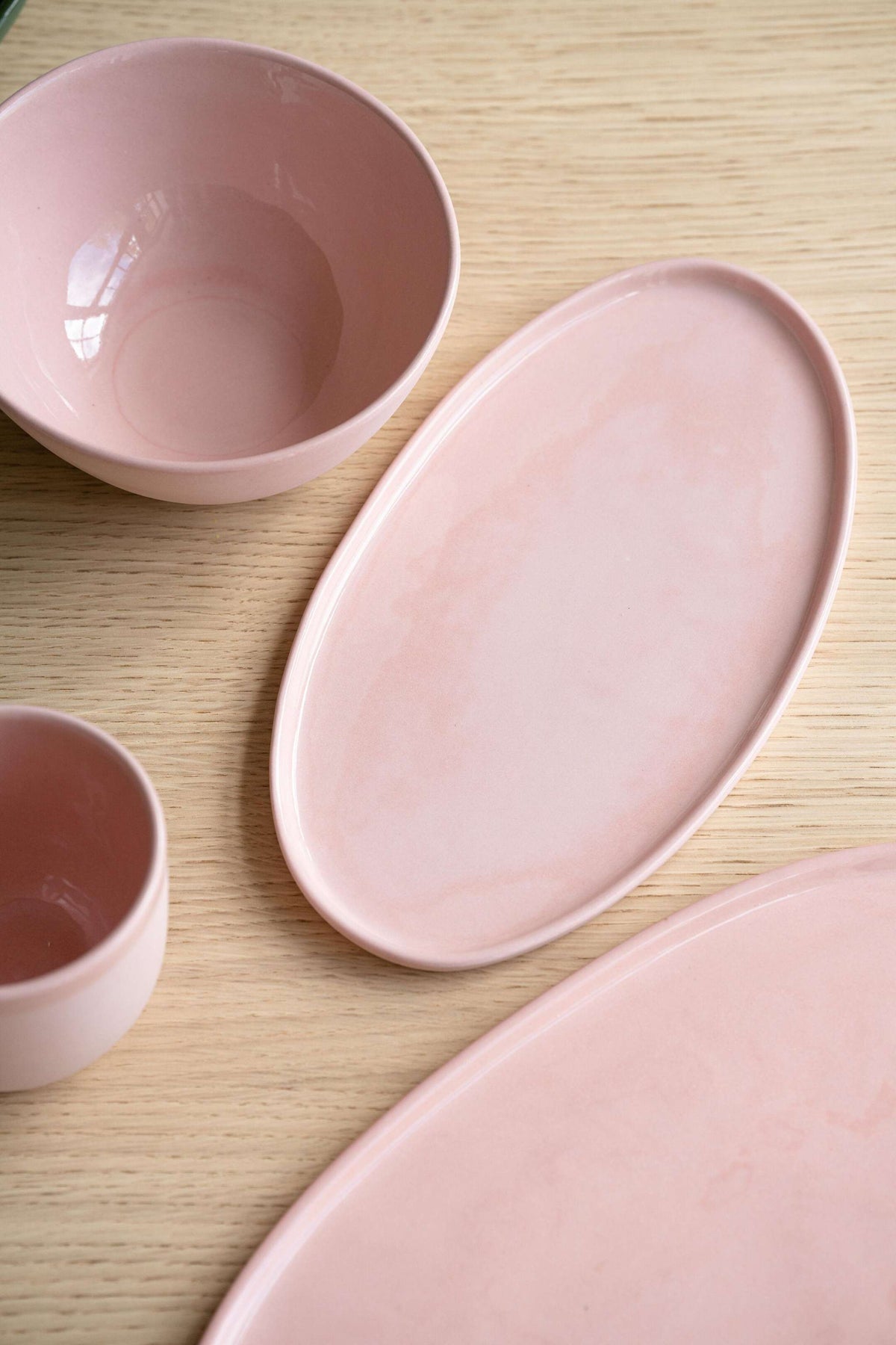 Handmade powder pink porcelain bowl with shiny glaze and smooth finish
