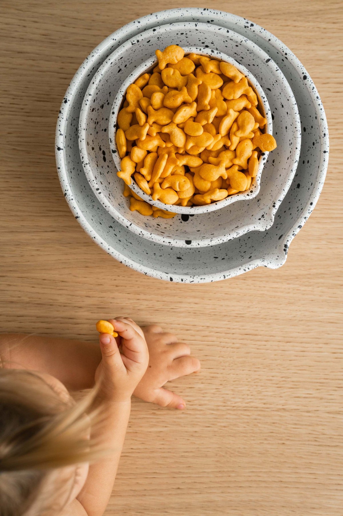 Set of deep stoneware mixing and serving bowls with pour spouts and artisanal speckled finish nesting for easy storage