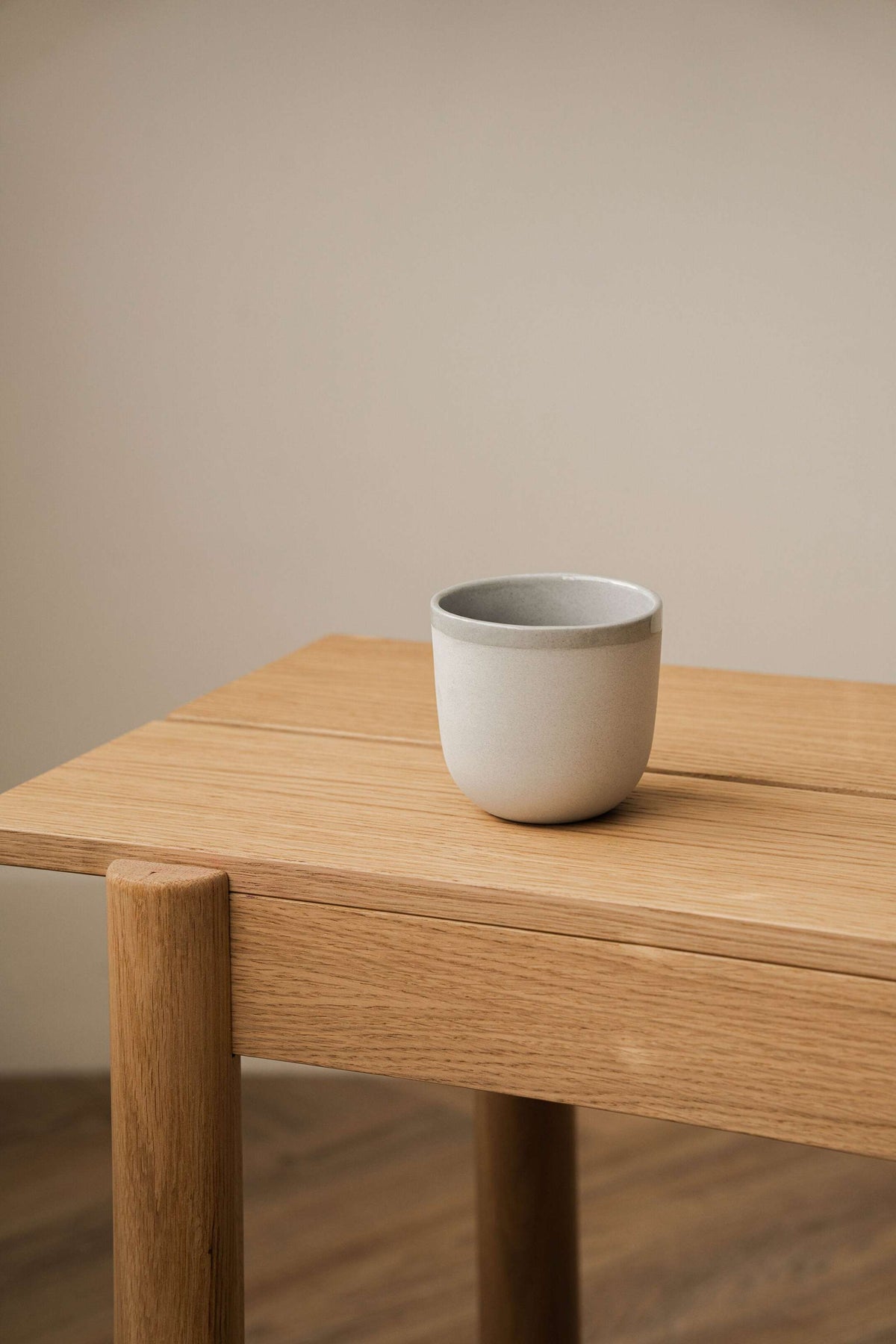 Handmade porcelain coffee cup in gray sky color with shiny glaze and smooth polished finish