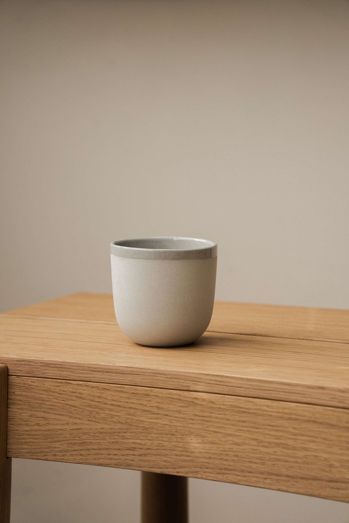 Handmade porcelain coffee cup in gray sky color with shiny glaze and smooth finish