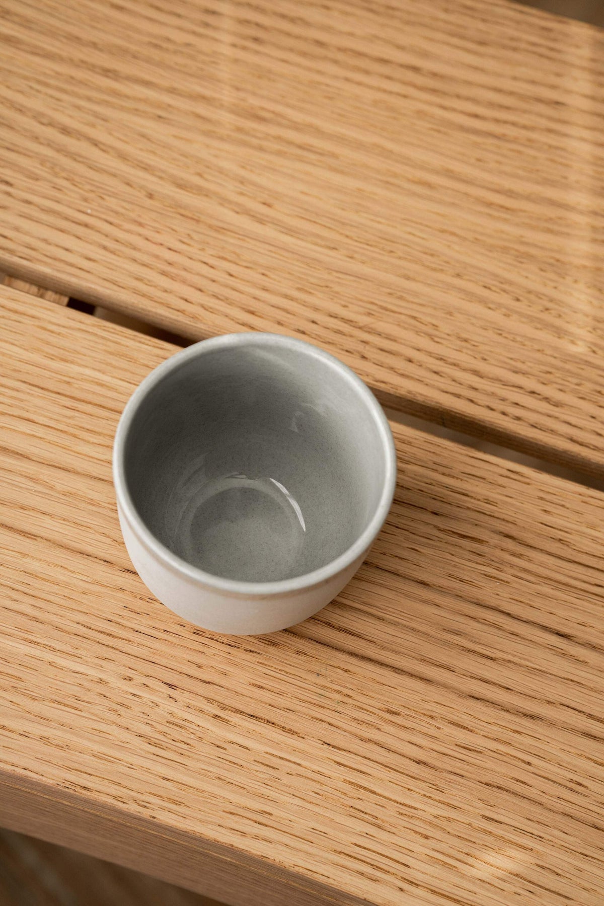 Handmade porcelain coffee cup in gray sky color with shiny glaze and smooth finish