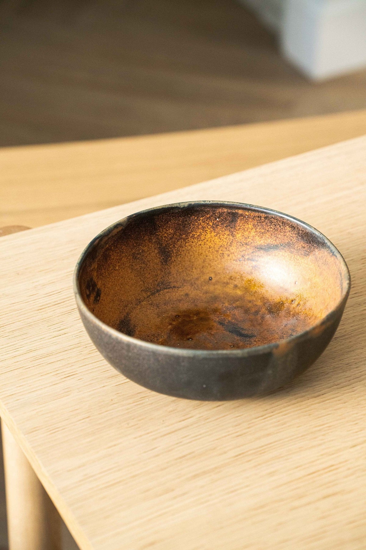 Rust stoneware nesting bowl set with matte brown-black reactive glaze, handmade and stackable