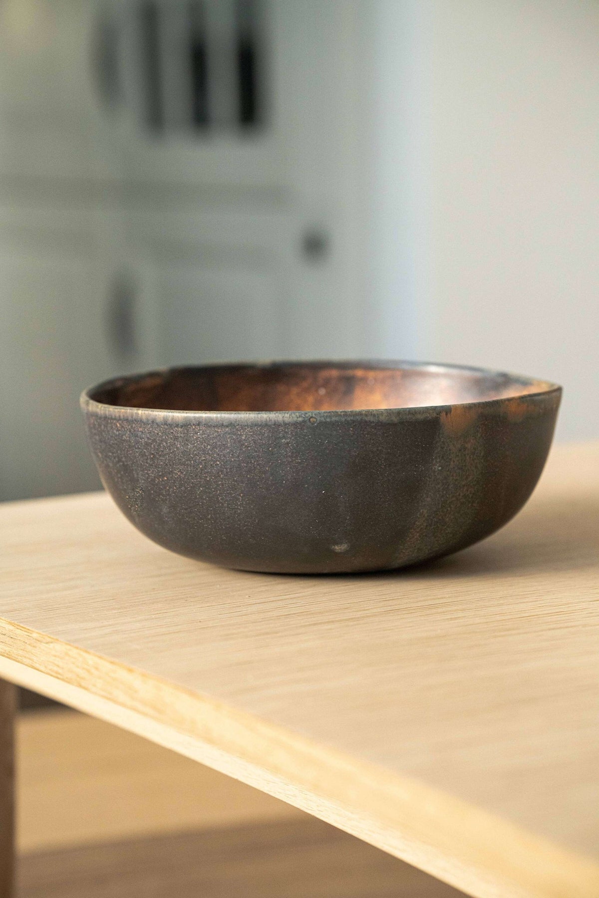 Rust stoneware nesting bowl set with matte brown-black reactive glaze, handmade and stackable