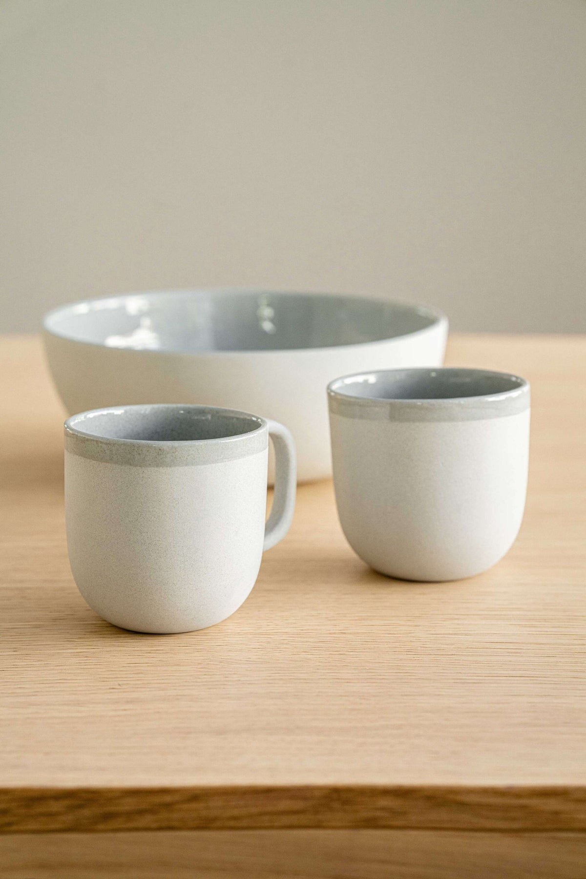 Handmade porcelain coffee cup in gray sky color with shiny glaze and smooth finish