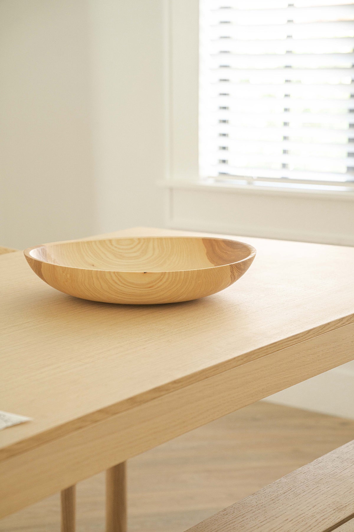 Hand-carved shallow ash wood fruit bowl with natural color gradient, 16-inch diameter, handmade in Ukraine