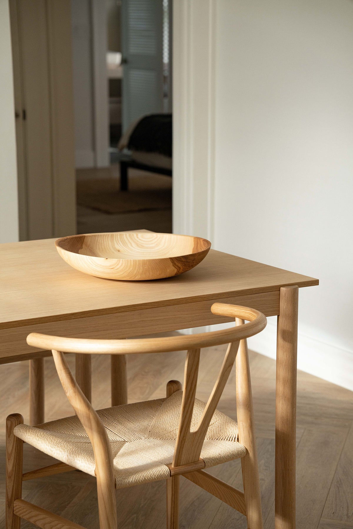 Hand-carved shallow ash wood fruit bowl with natural beige to brown gradient, 16-inch diameter, handmade in Ukraine.