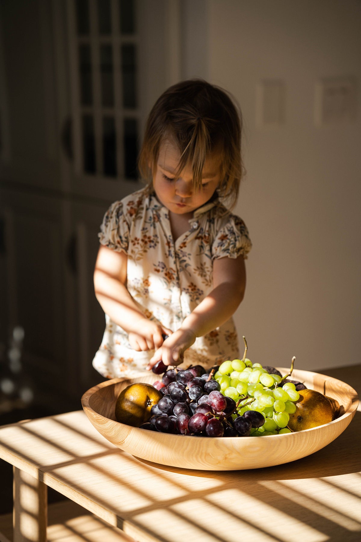 Hand-carved shallow ash wood fruit bowl with natural color gradient, 16-inch diameter, handmade in Ukraine