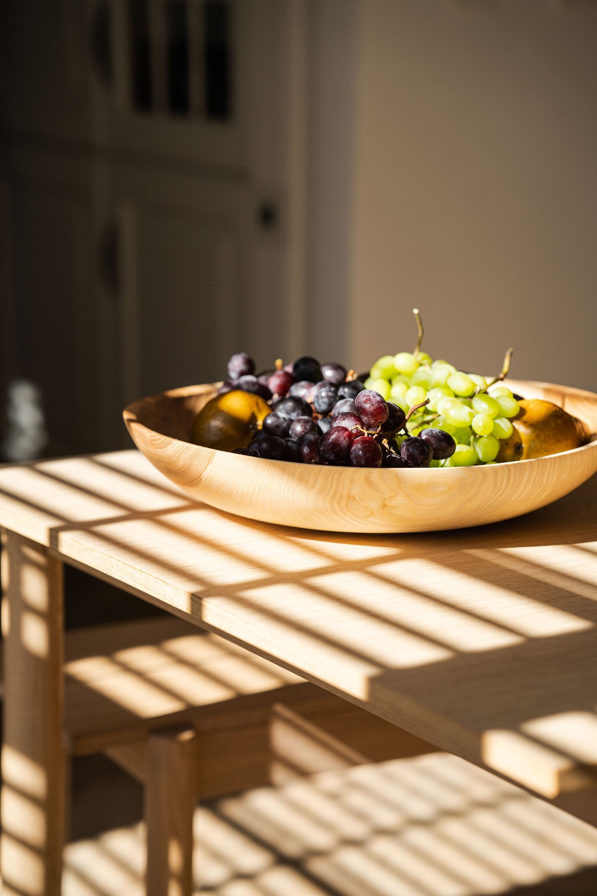 Hand-carved shallow ash wood fruit bowl with natural color gradient, 16-inch diameter, handmade in Ukraine