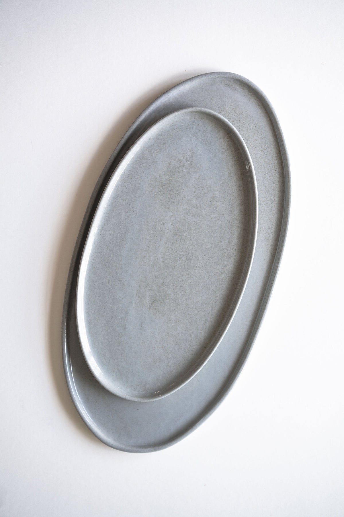 Handmade porcelain oval serving platter in gray sky color with organic edges