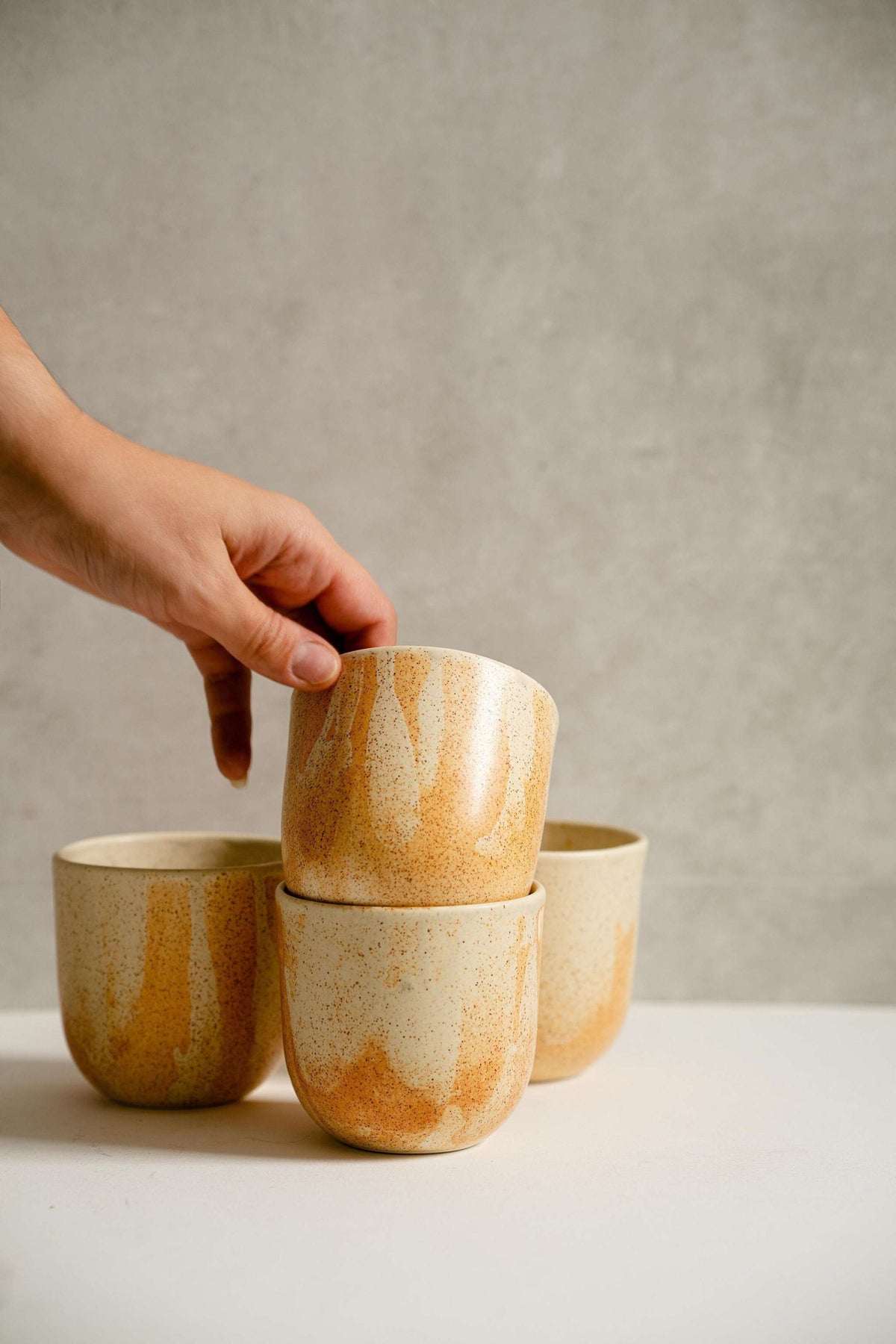 Handmade stoneware beige coffee cup with organic edges and reactive glaze swirl, 11 oz, durable and dishwasher safe