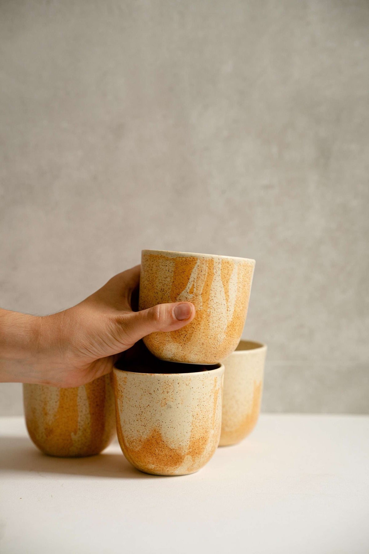 Handmade stoneware beige coffee cup with organic edges and reactive glaze swirl, 11 oz, durable and food-safe, made in Ukraine