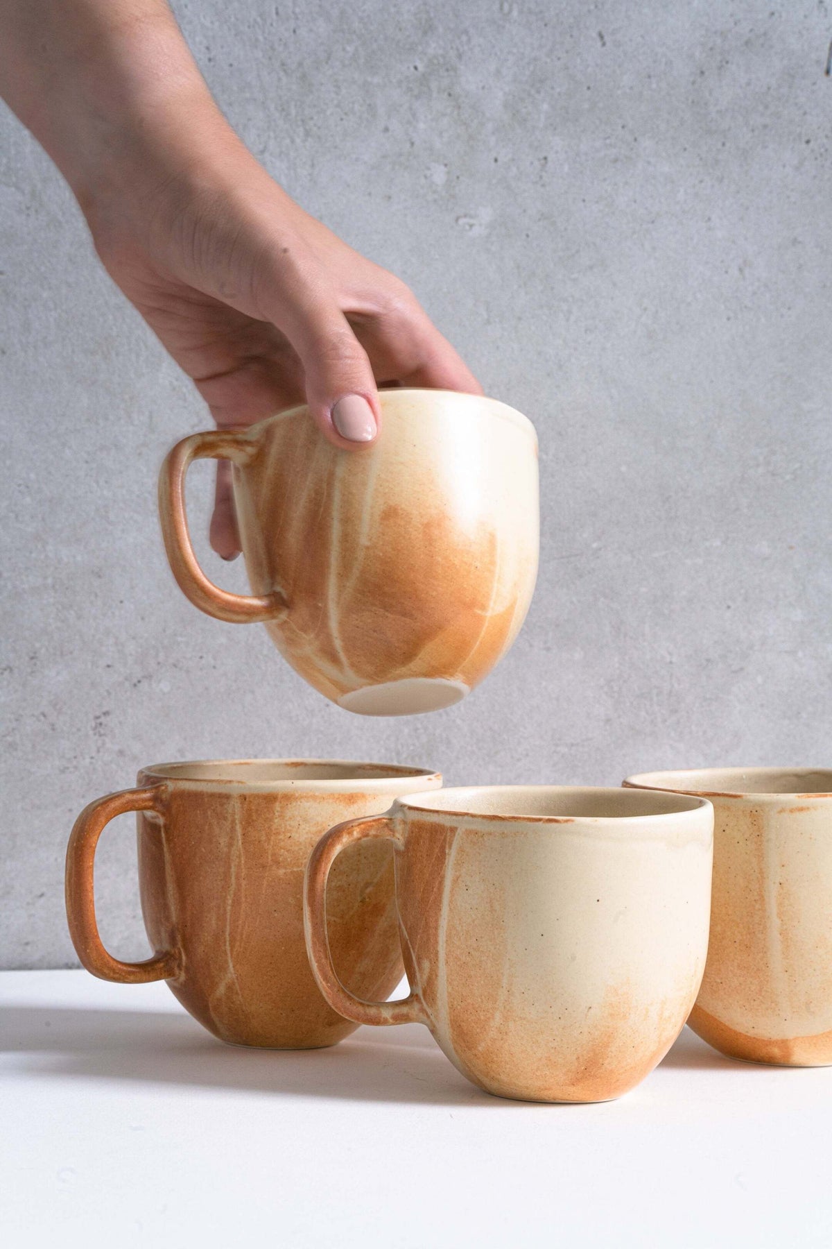 Stoneware beige coffee mug with handle and unique reactive glaze swirl, handmade in Ukraine, dishwasher and microwave safe