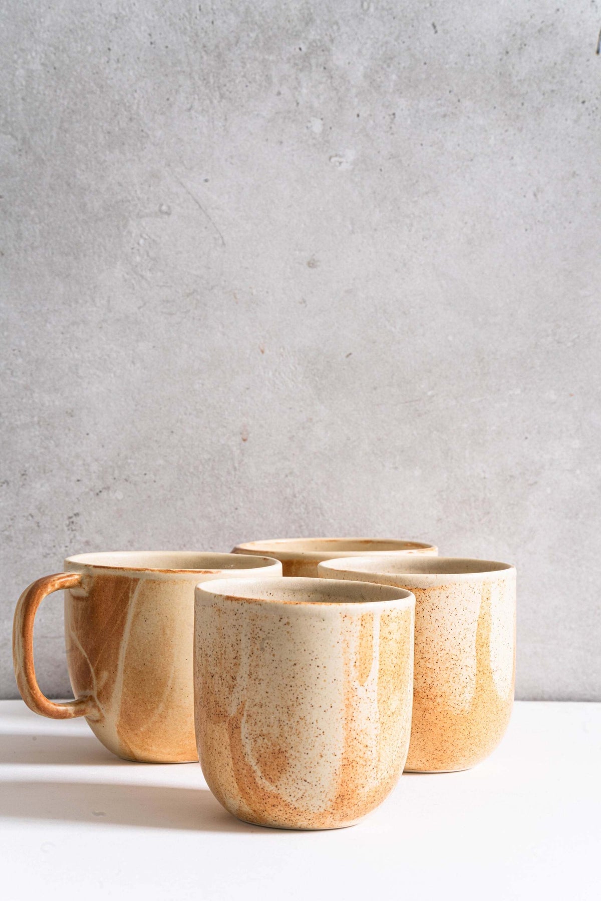 Handmade stoneware beige coffee cup with organic edges and reactive glaze rust drips, 11 oz, durable and dishwasher safe