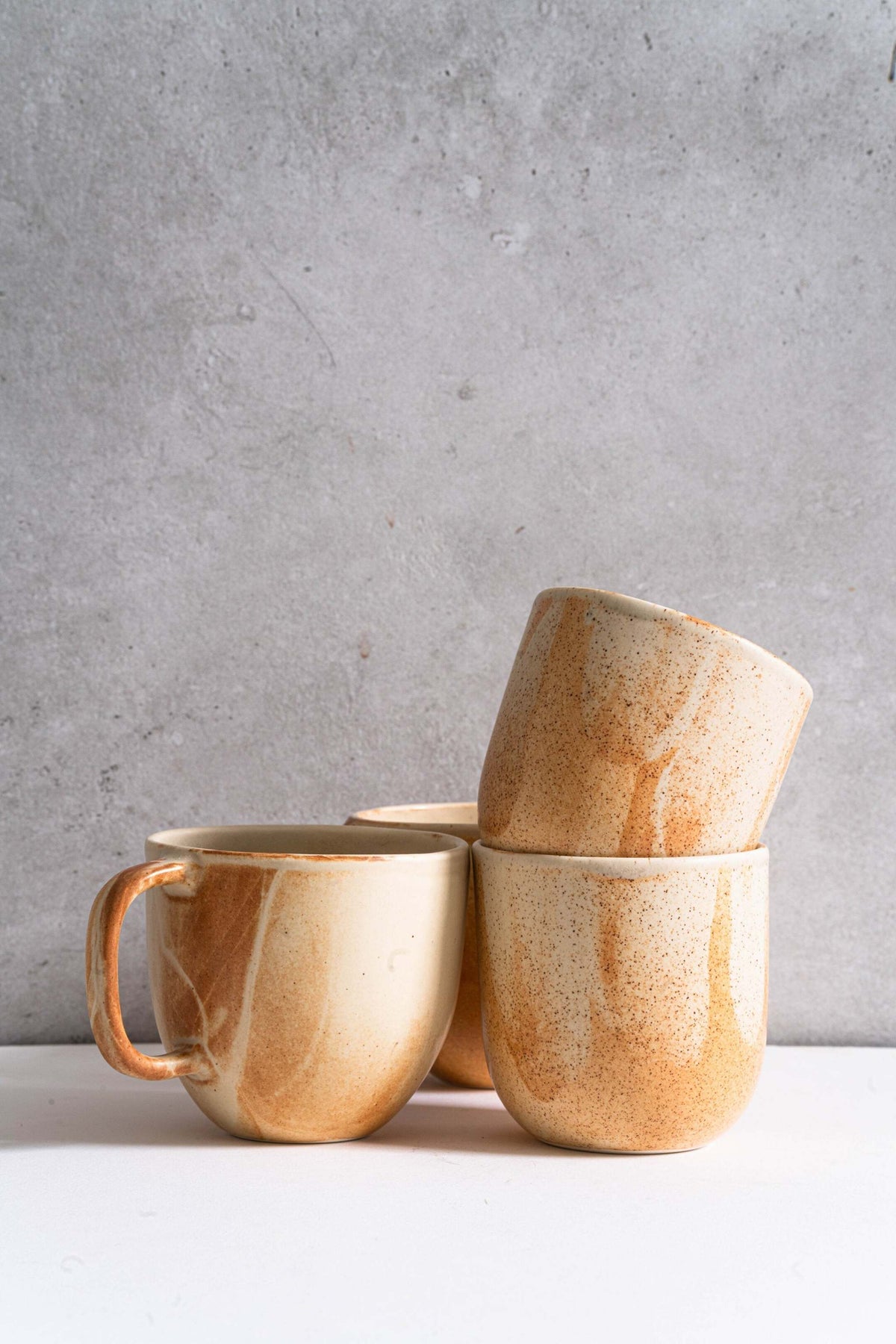 Handmade stoneware beige coffee cup with organic edges and reactive glaze swirl, 11 oz, microwave and dishwasher safe