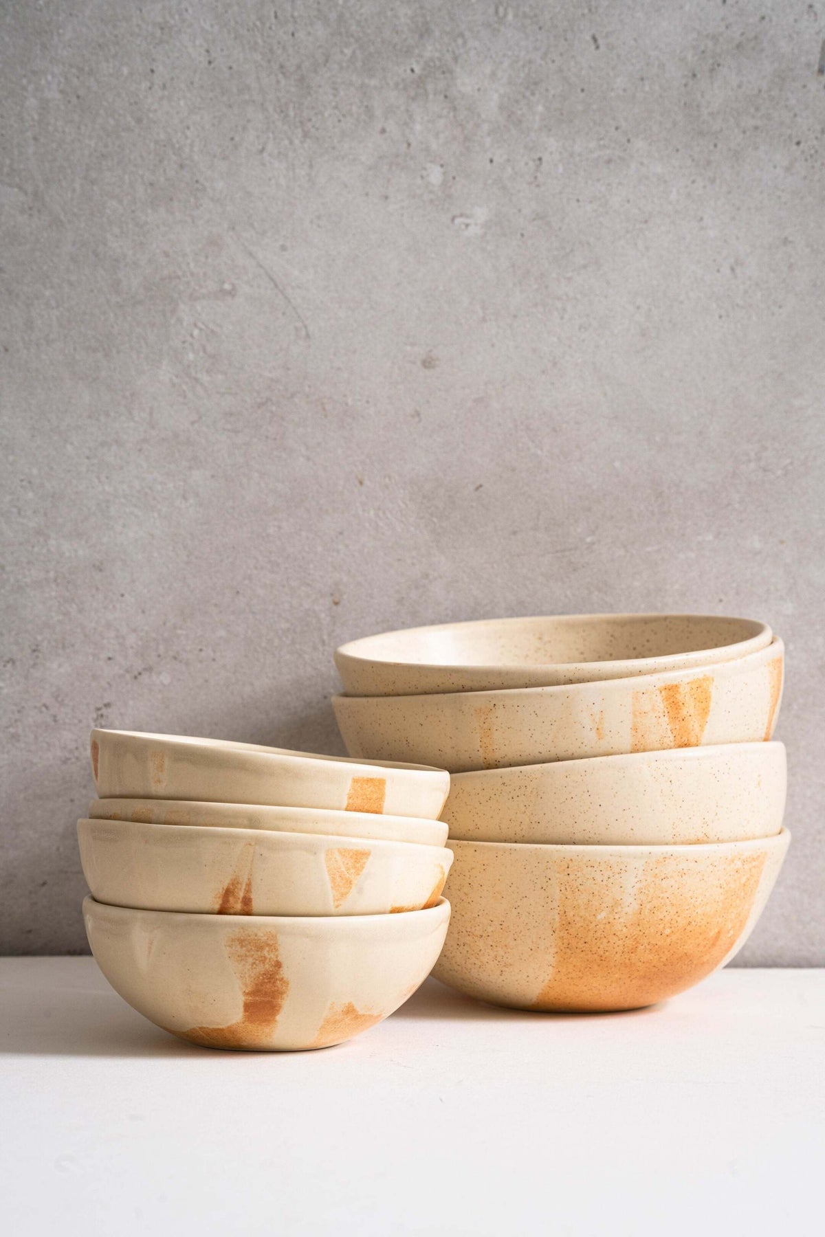 Beige matte stoneware bowl with unique reactive glaze and rust color strokes, handmade in Ukraine