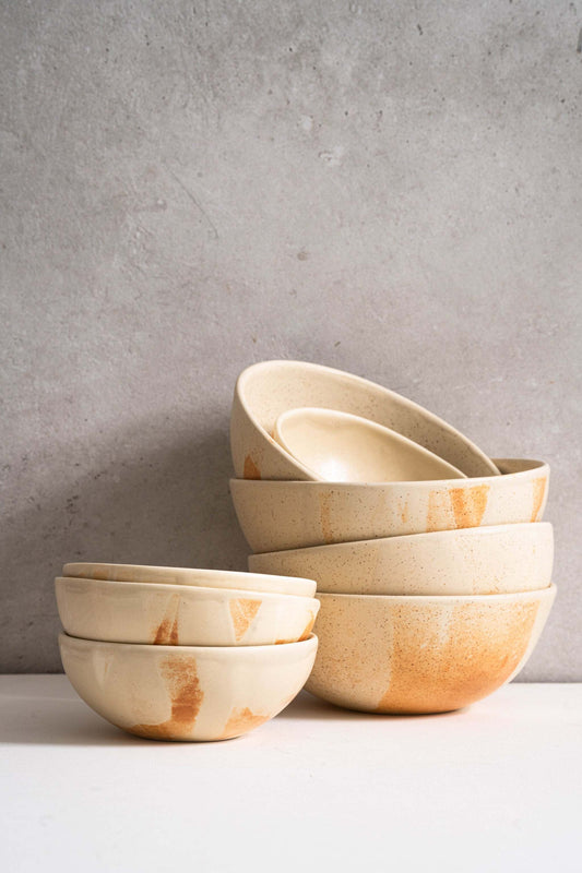 Beige matte stoneware bowl with reactive glaze and rust color strokes, handmade in Ukraine