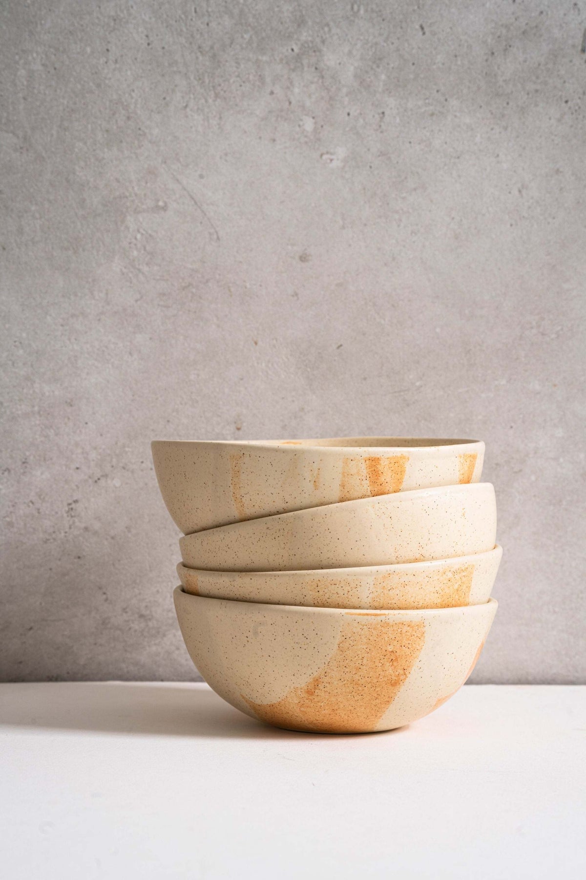 Beige matte stoneware bowl with unique reactive glaze and rust color strokes, handmade in Ukraine