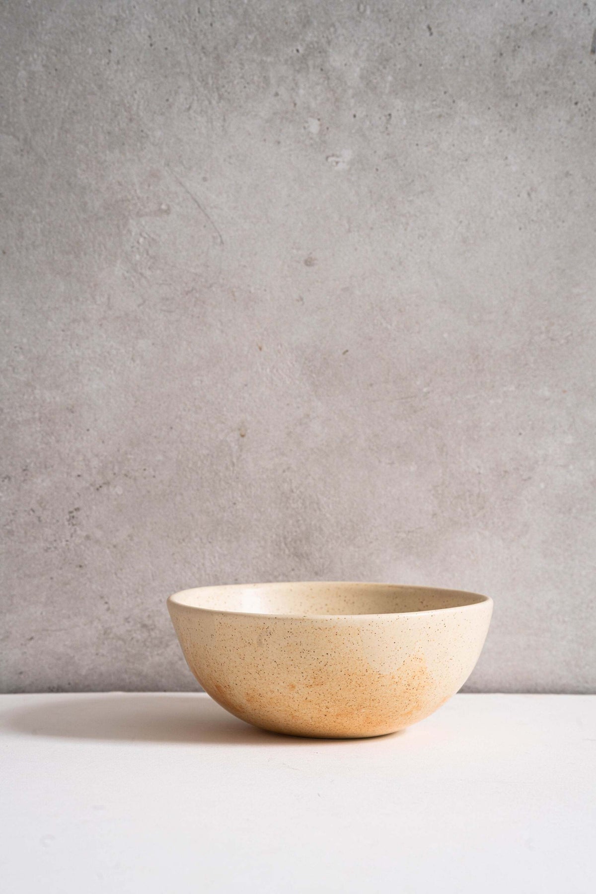 Beige matte stoneware bowl with unique reactive glaze and rust color strokes, handmade in Ukraine, dishwasher and microwave safe