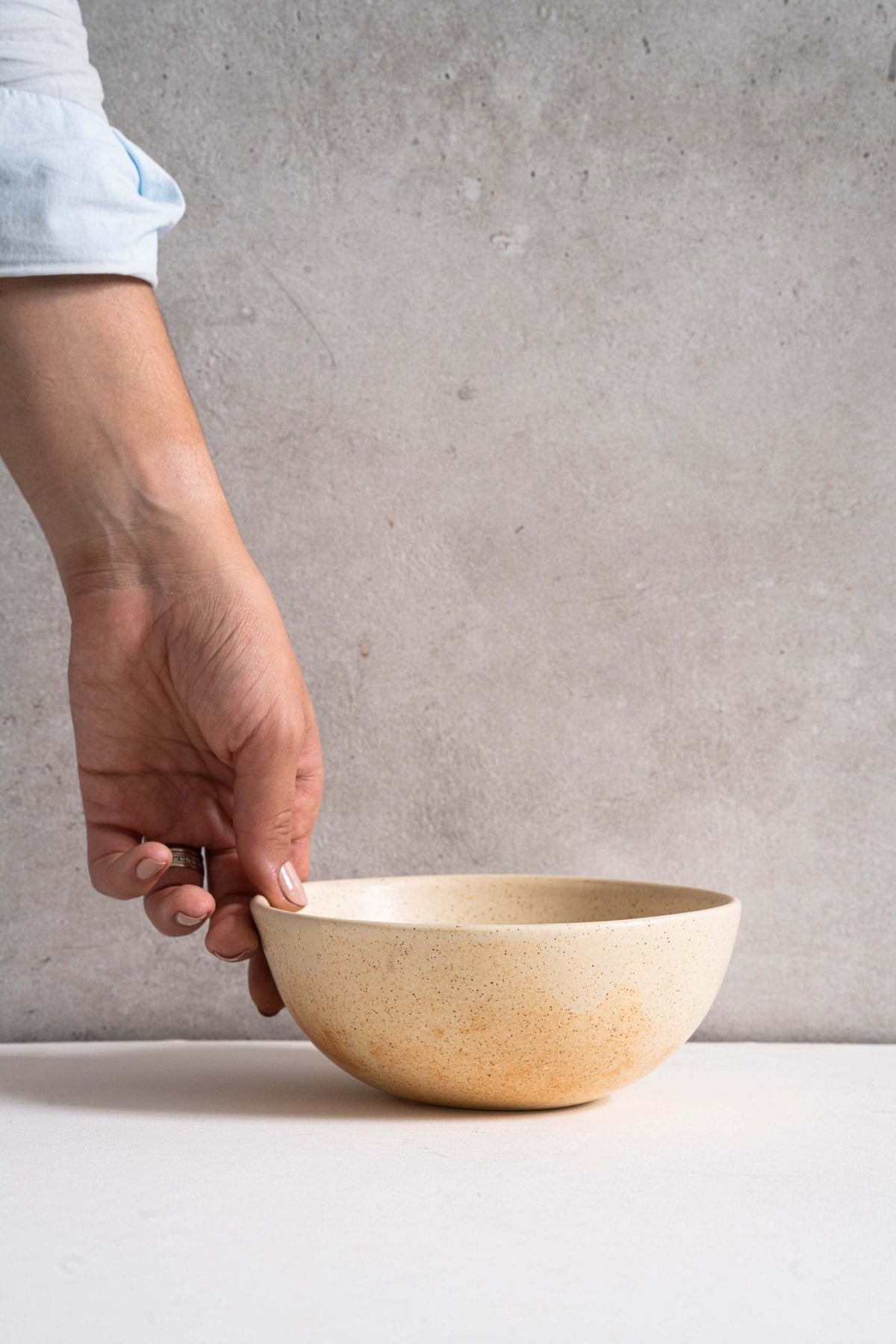 Beige matte stoneware bowl with unique reactive glaze and rust color strokes, handmade in Ukraine